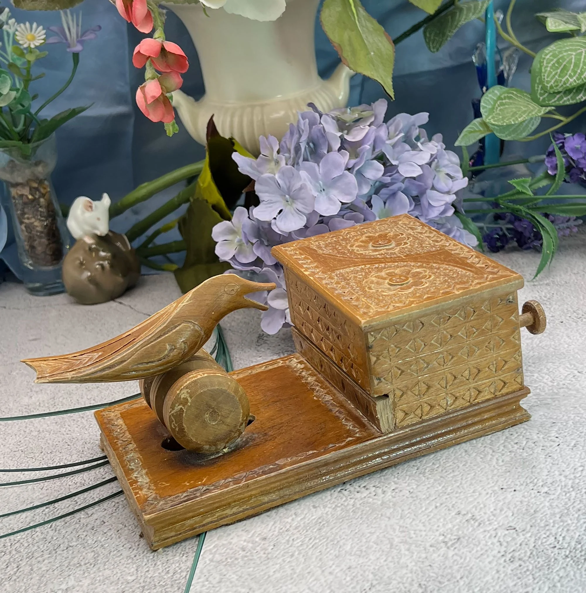 Carved wood cigarette dispenser with pecking bird