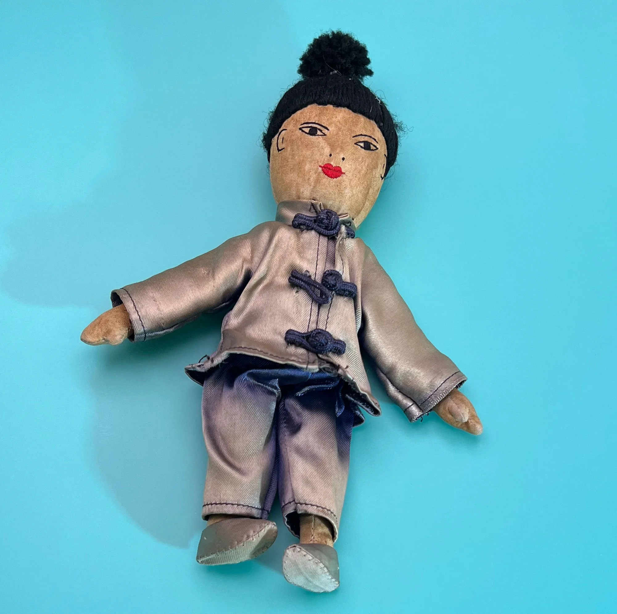 Vintage Chinese doll in faded blue outfit