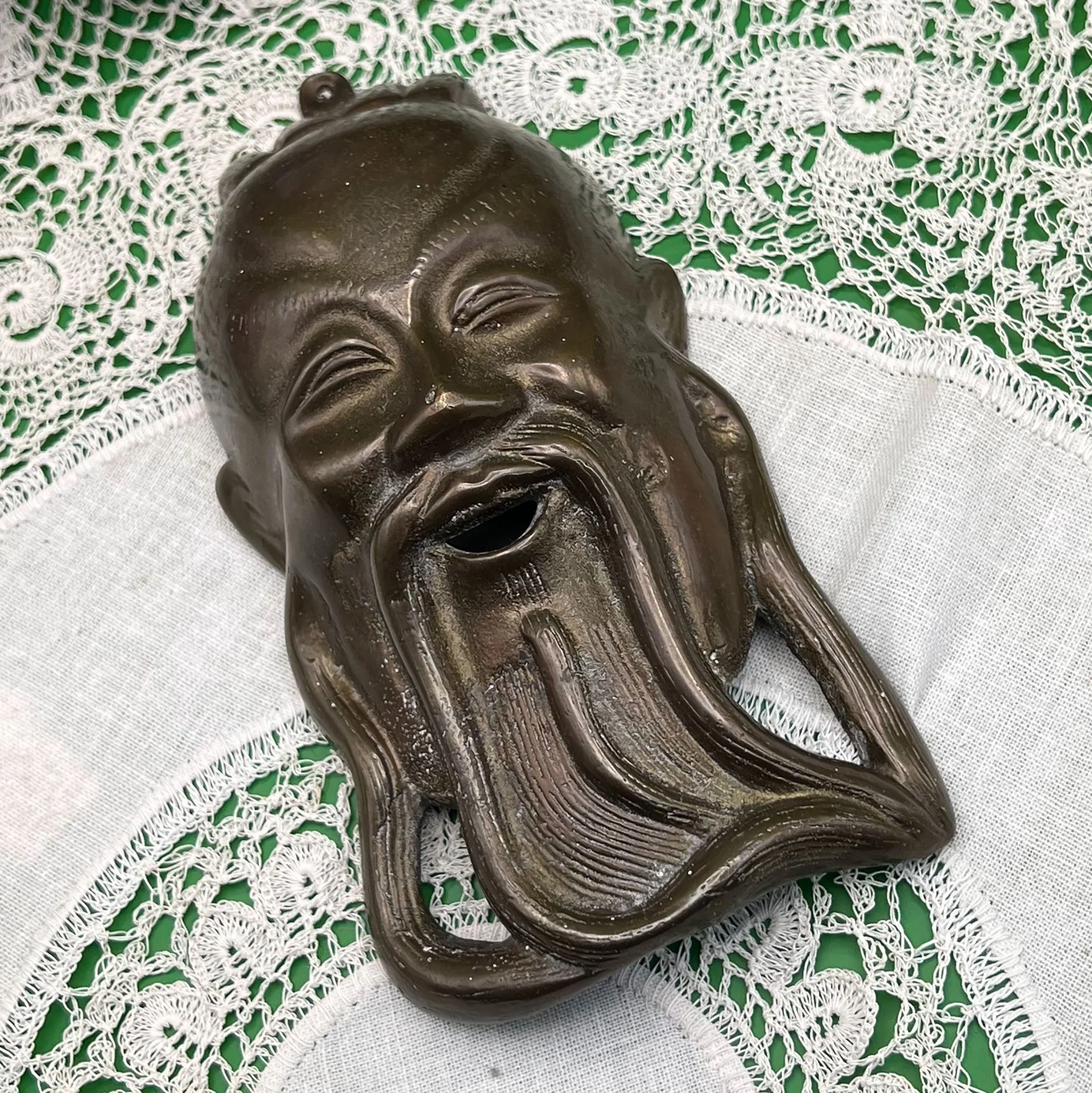 Bronze Buddha wall mask