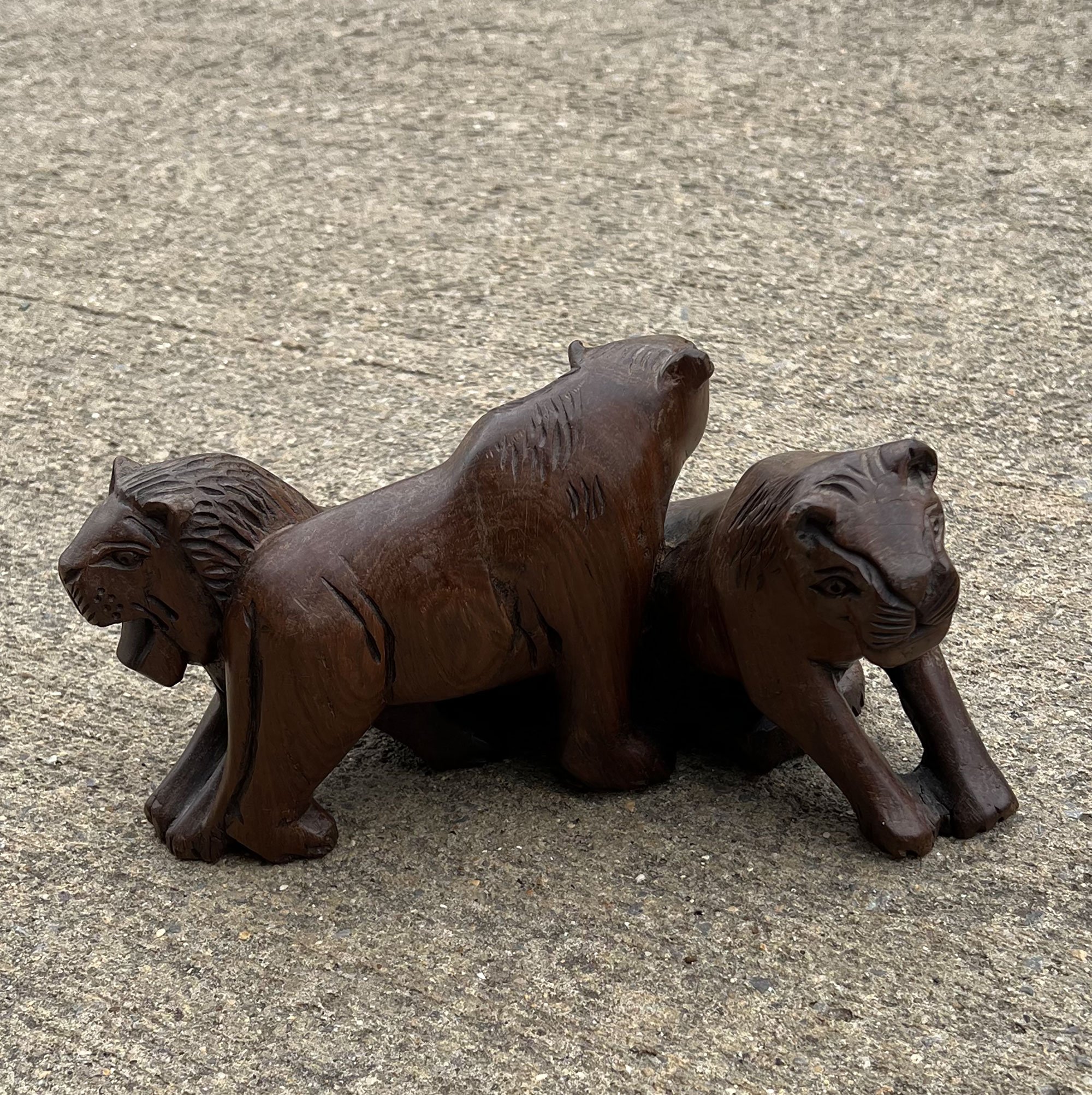 Carved wood lion group