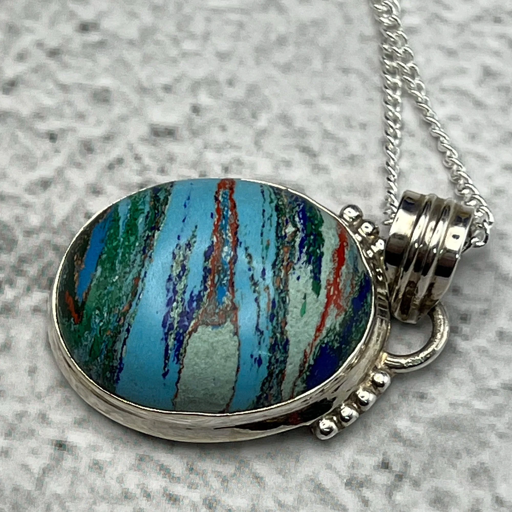 Rainbow Calsilica pendant set in silver