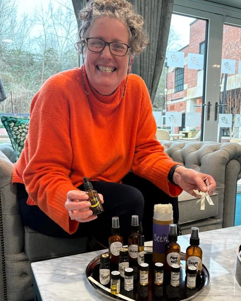 Lisa Jo Founder of Priddy Presence showcasing her essential oil blends at a demonstration of wellbeing