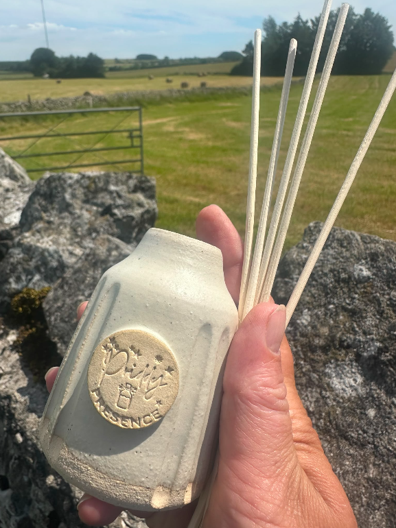 Handmade ceramic reed diffuser crafted by Lowen Clay, with natural reeds and seasonal essential oil blend, part of the Rituals of Presence collection.