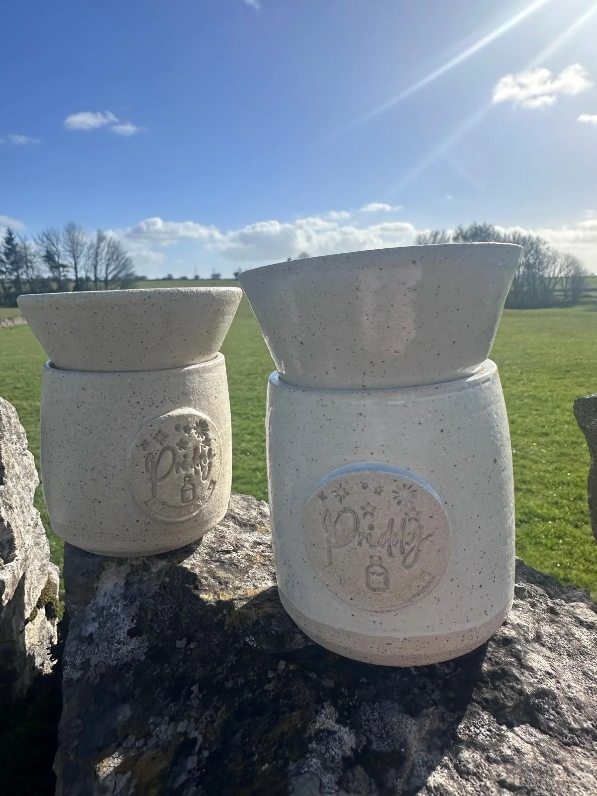 two handmade clay oil burners