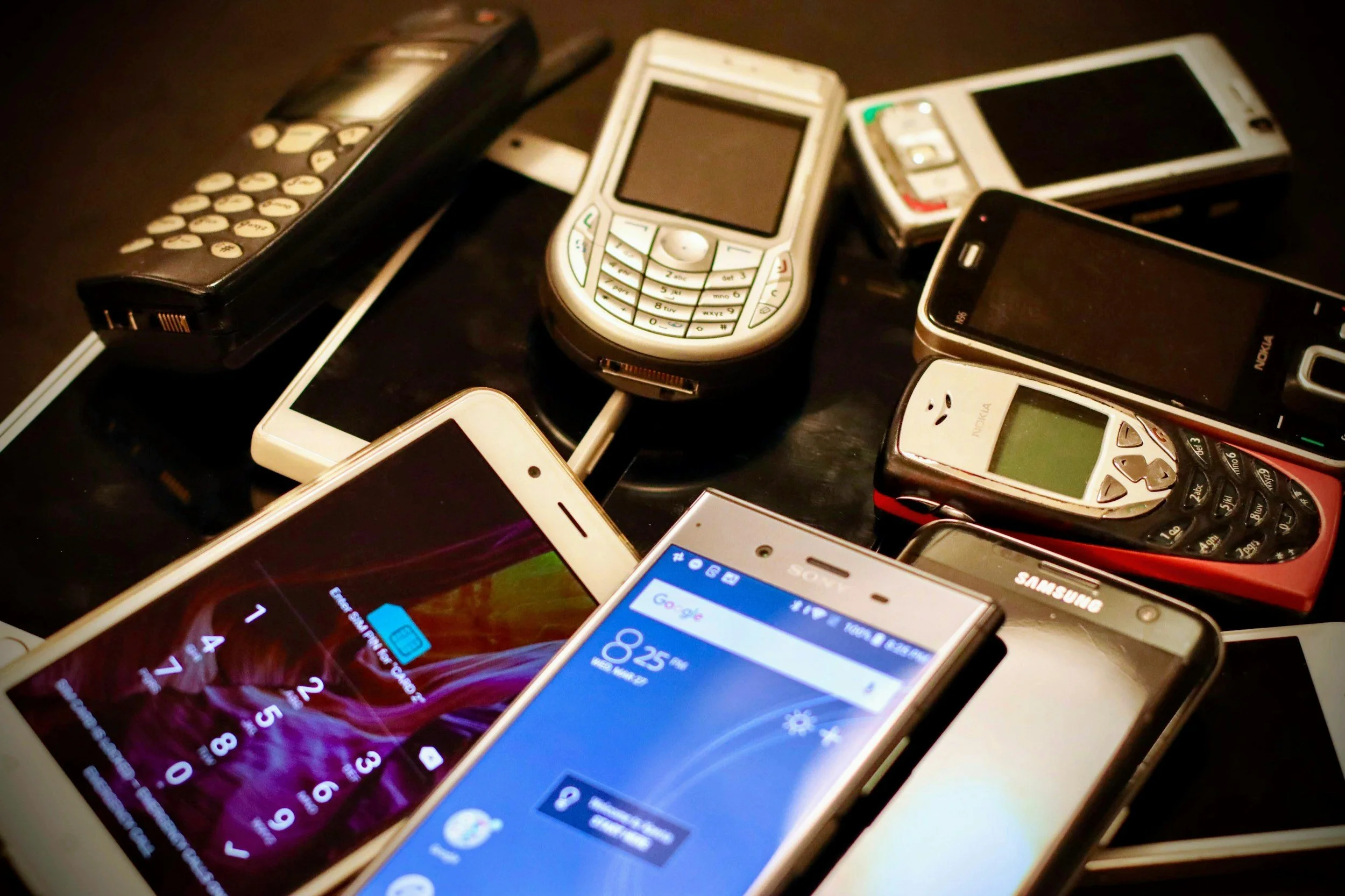 Assortment of old mobile phones ready for reuse or electronics recycling