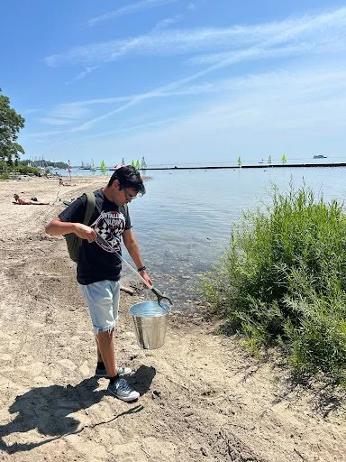 Volunteer Dev Pandey collecting litter at Budapest Park in Toronto