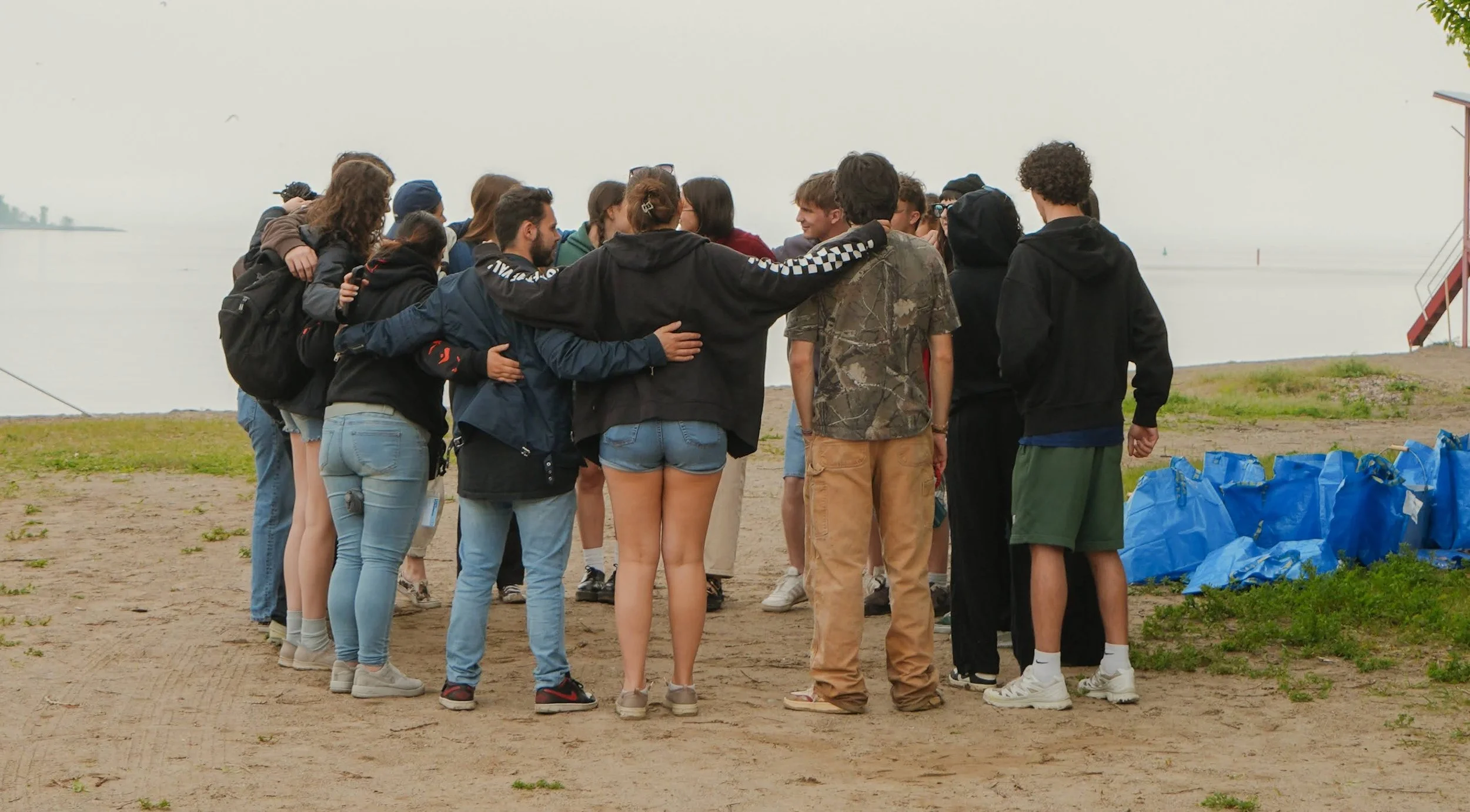 Friends in a huddle after a litter cleanup