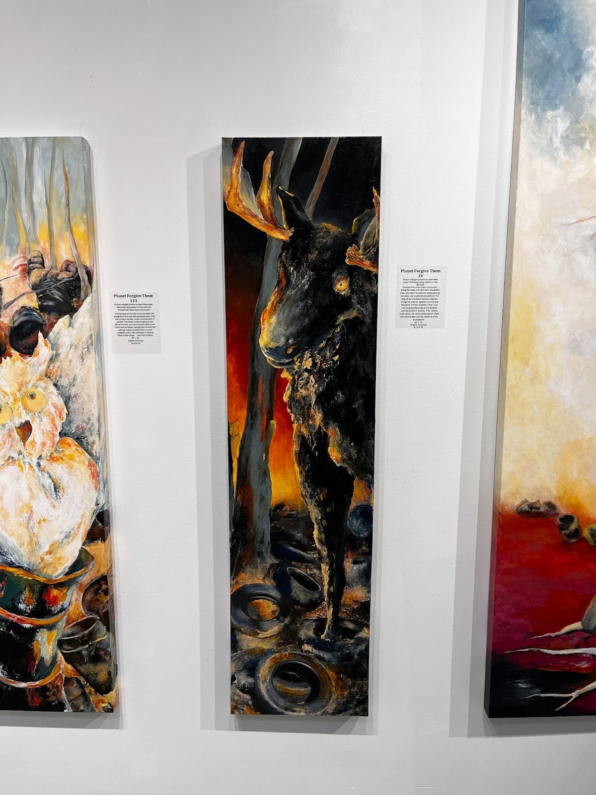Vertical environmental art panels by Brigitte Goudreau displayed in a gallery, combining abstract wildlife imagery with textured materials.