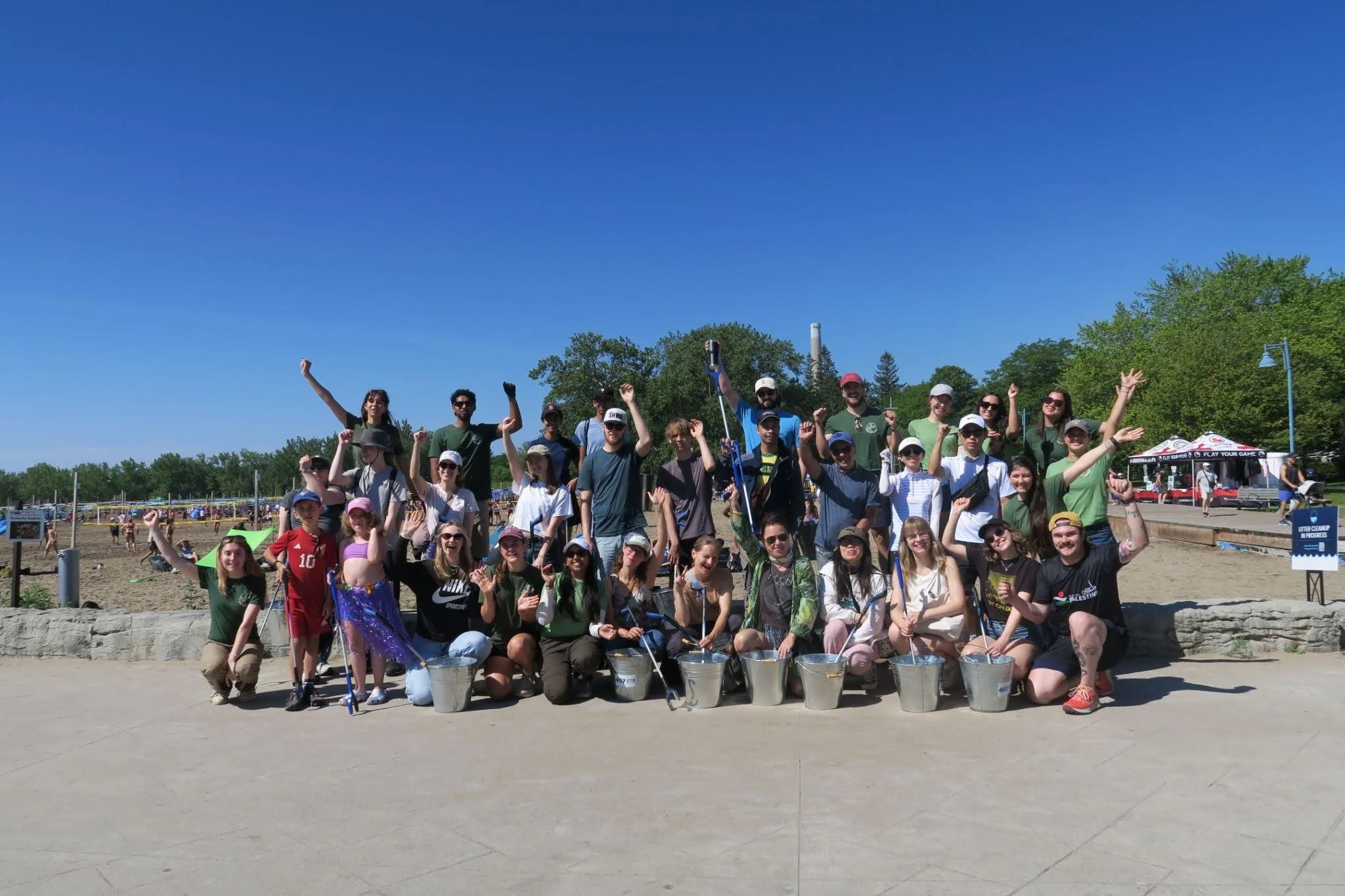 A Greener Future volunteers celebrating after a community cleanup at Woodbine Beach.