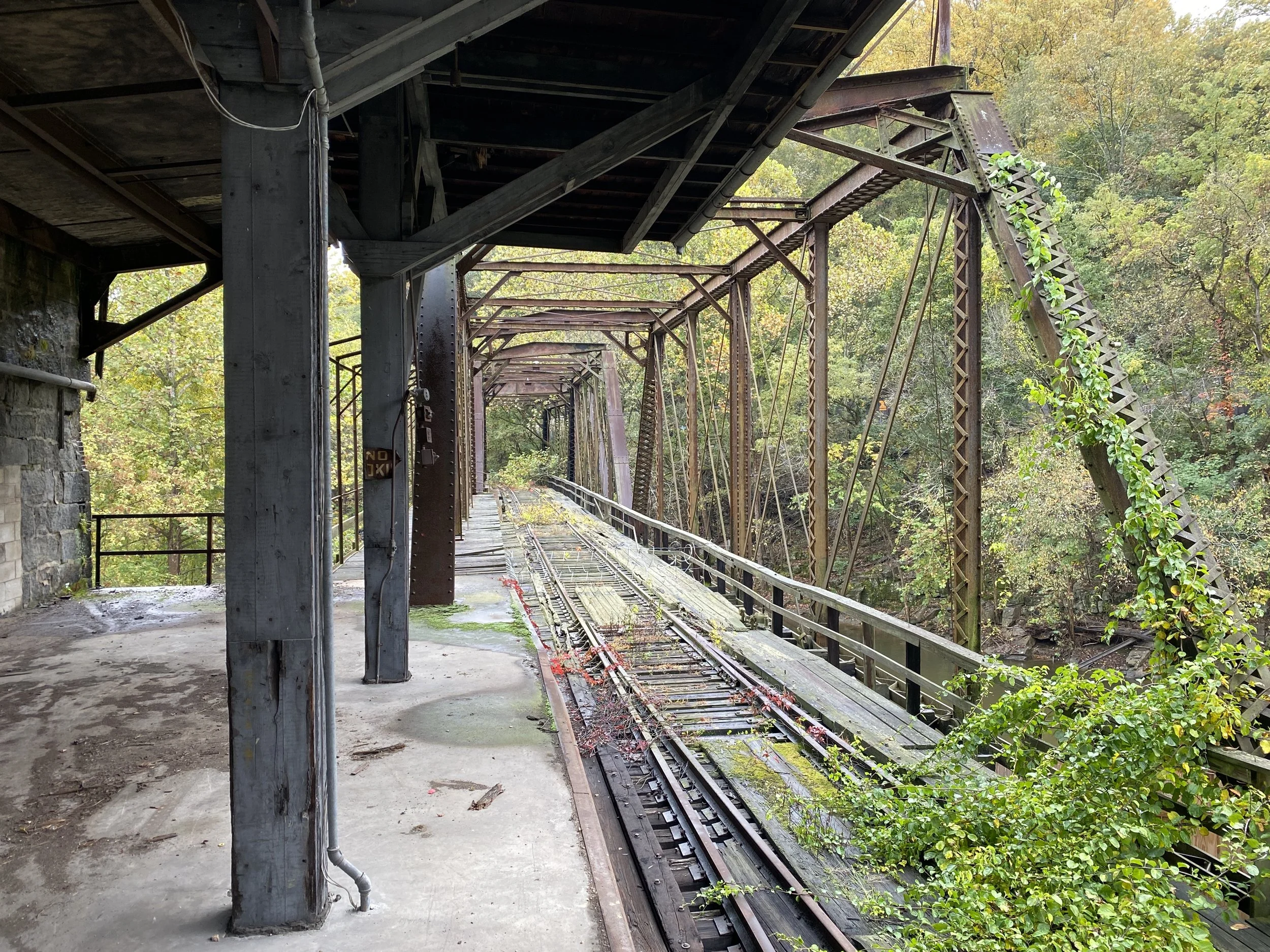 View looking southeast along railroad bridge from the mill
