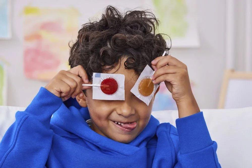  Kid holding lollipops lifestyle photography children's CPG brand campaign 