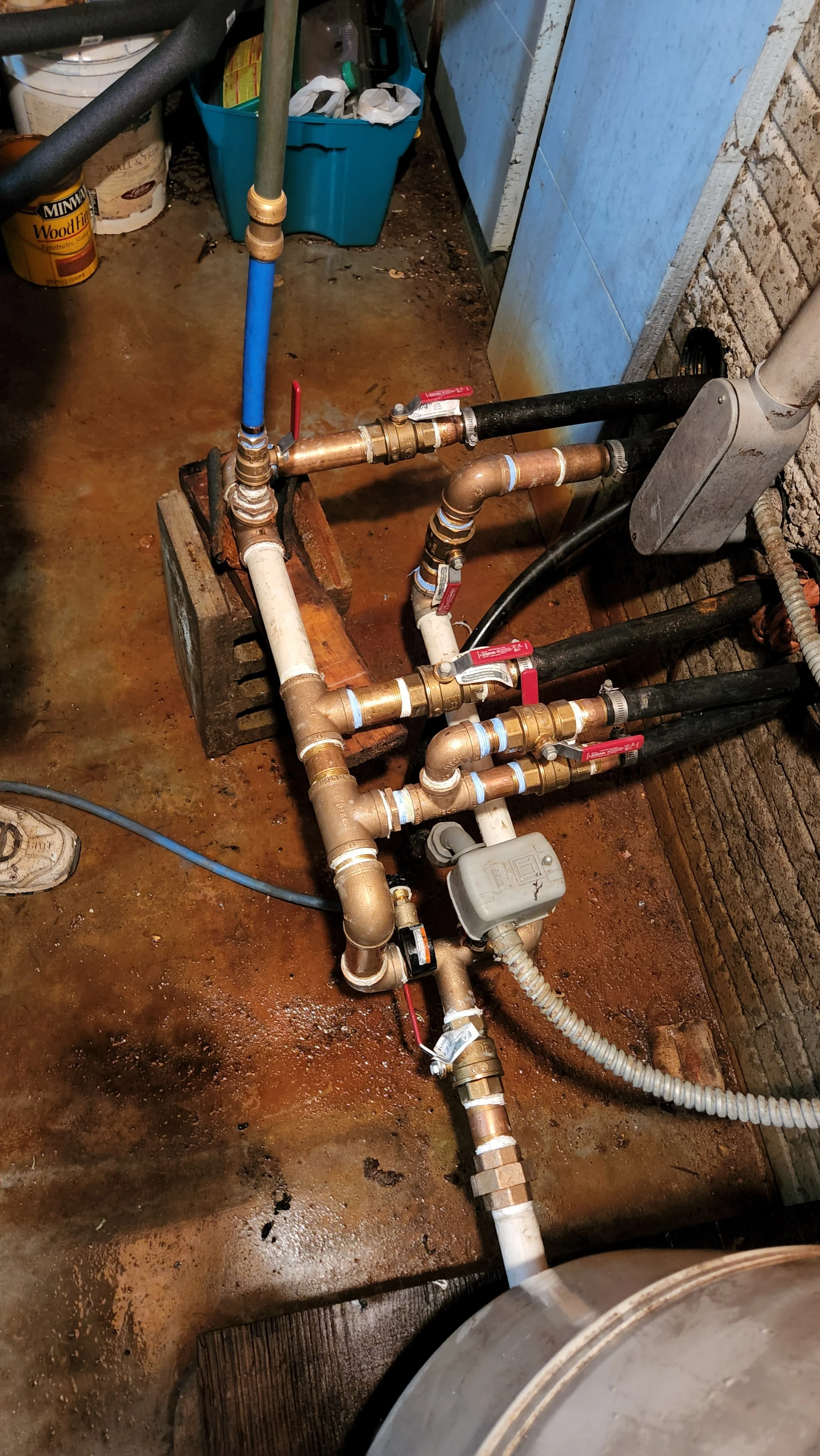 plumbing system with valves and pipes in basement