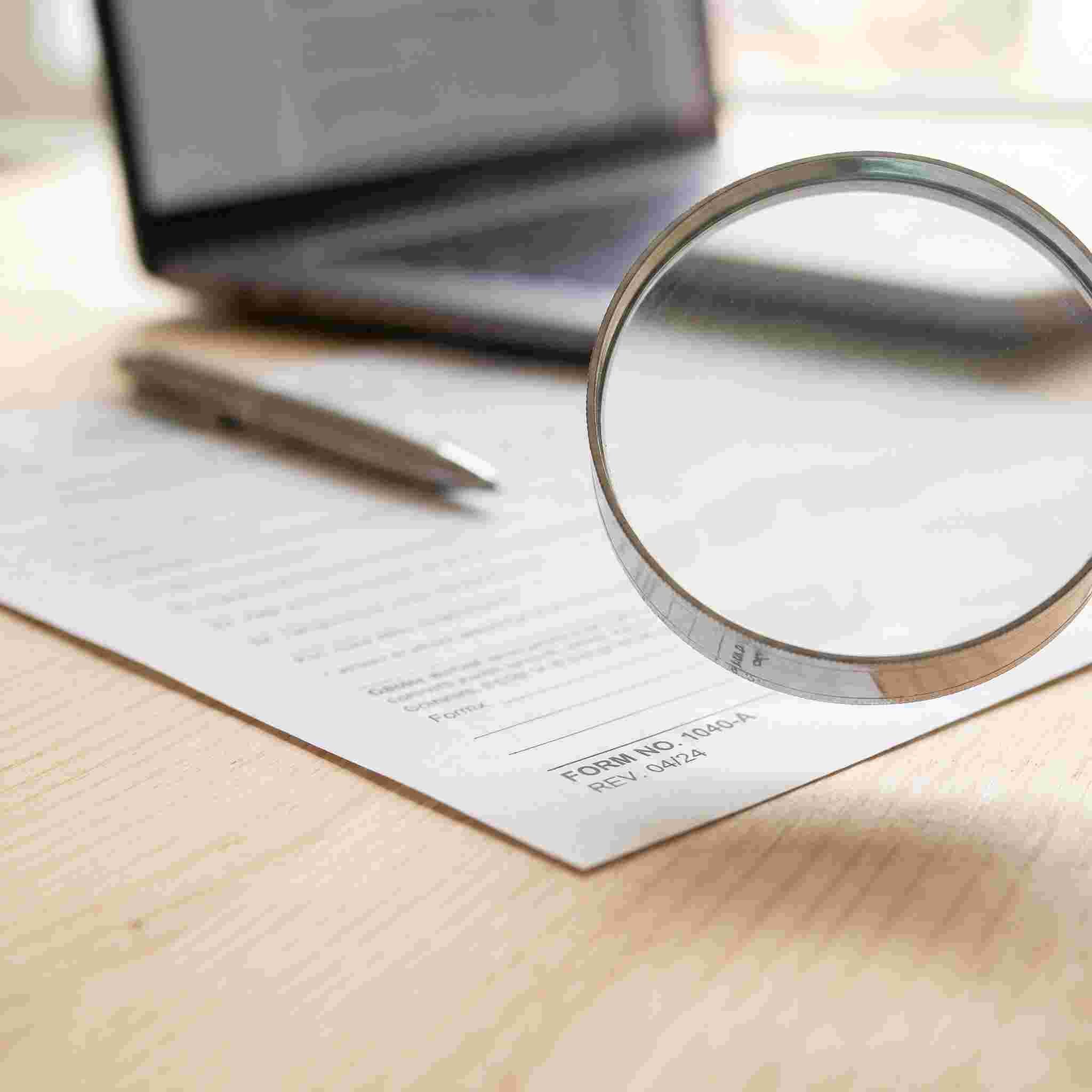 Magnifying glass over the revision stamp in the corner of a printed state form