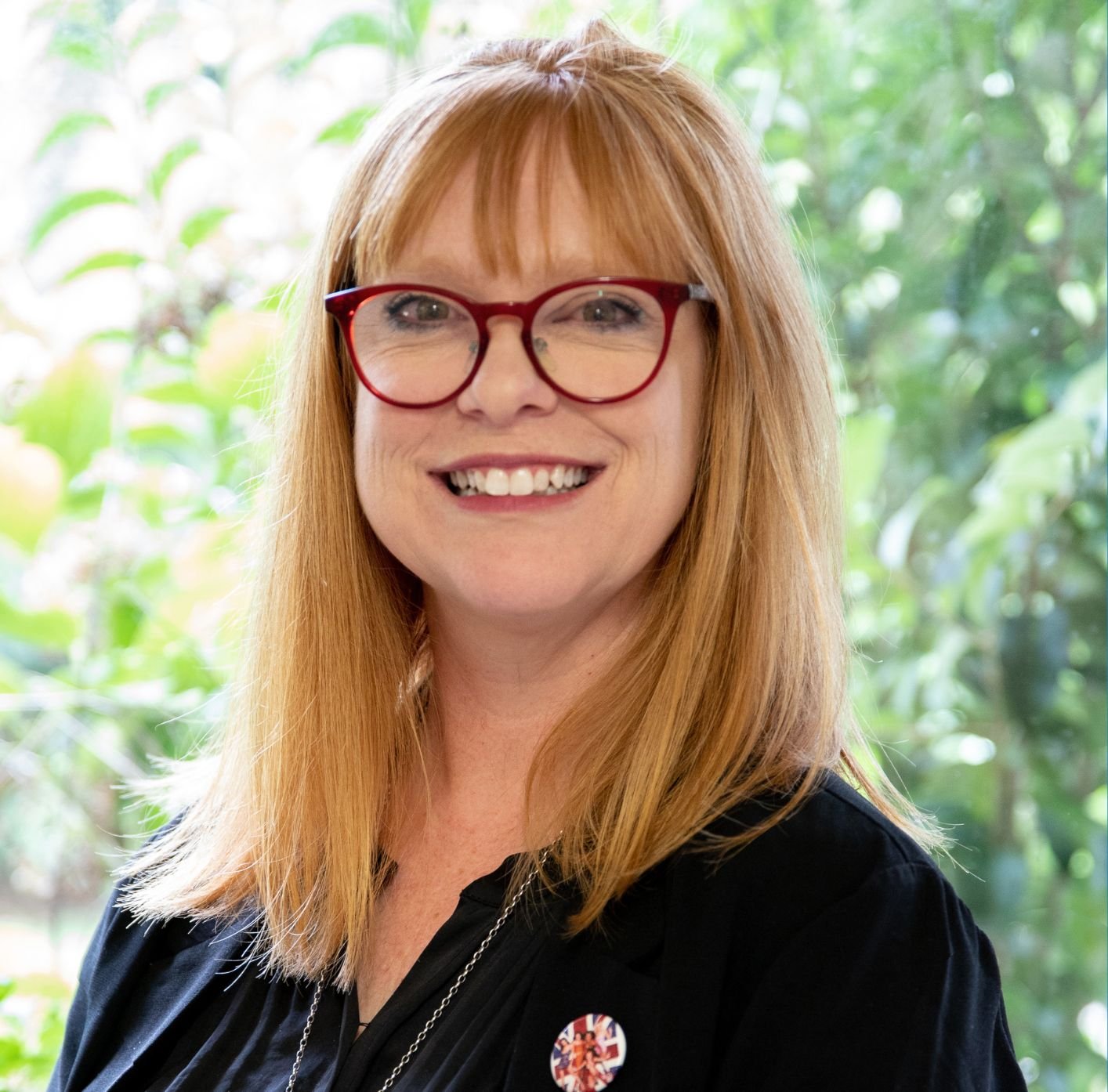 A headshot of a lady smiling at the camera