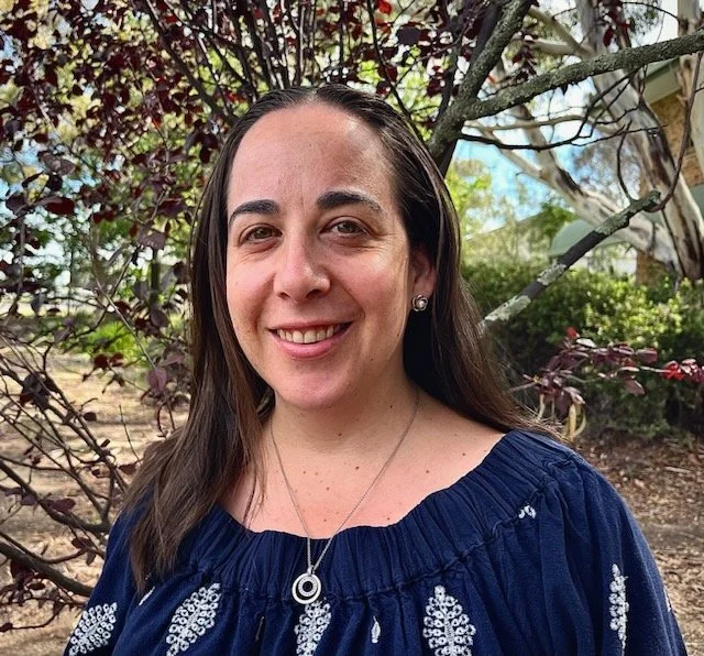 A headshot of a young lady smiling at the camera