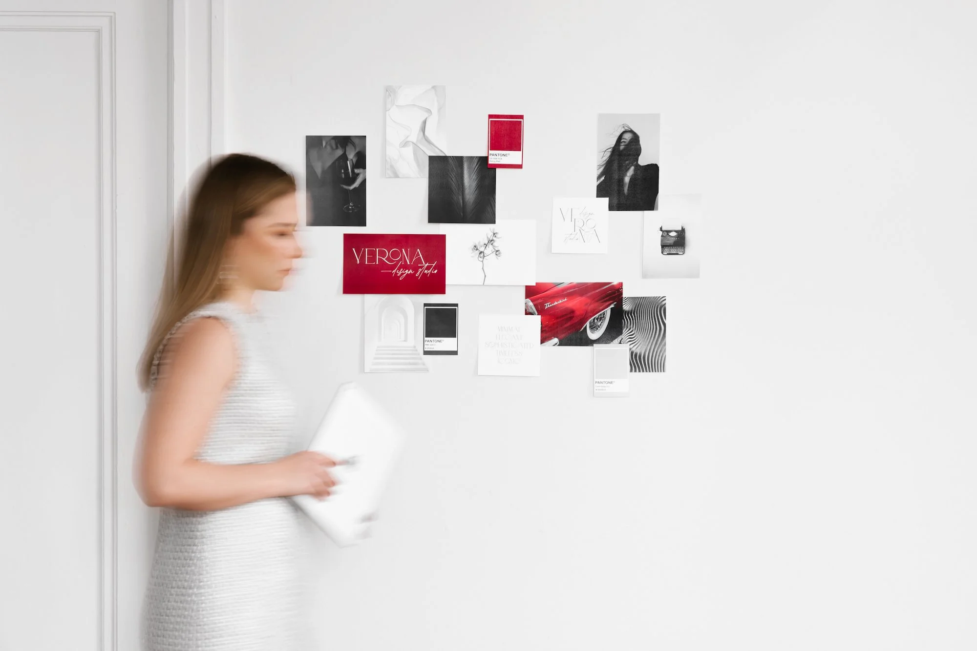 Brand and website designer walking past a studio inspiration wall during the creative process