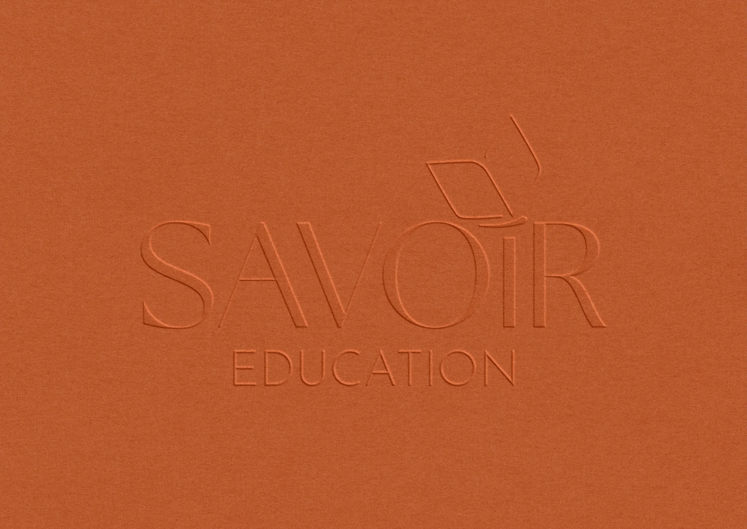 Savoir Education logo emboss mockup on textured stationery cover