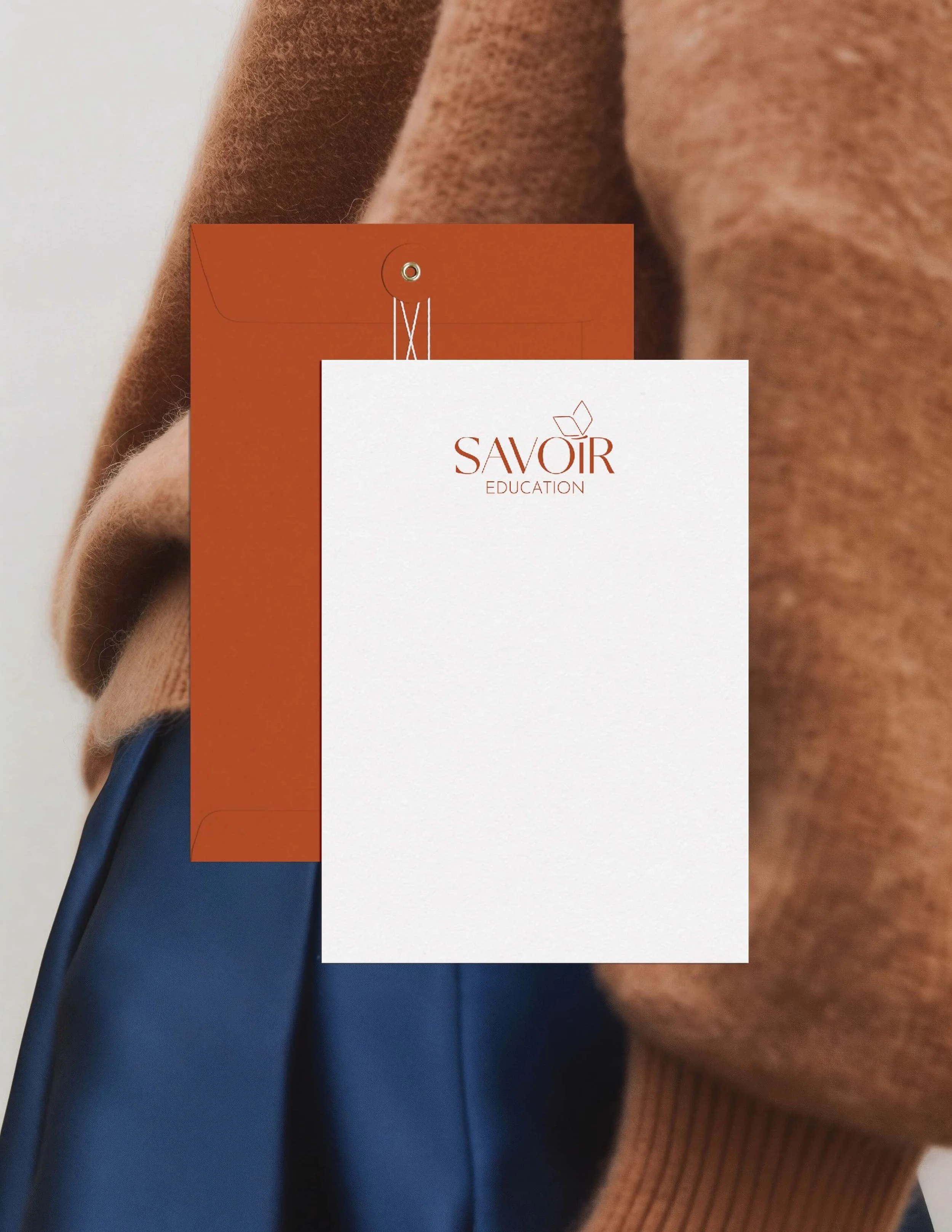 Savoir Education letterhead design and envelope mockup in terracotta palette