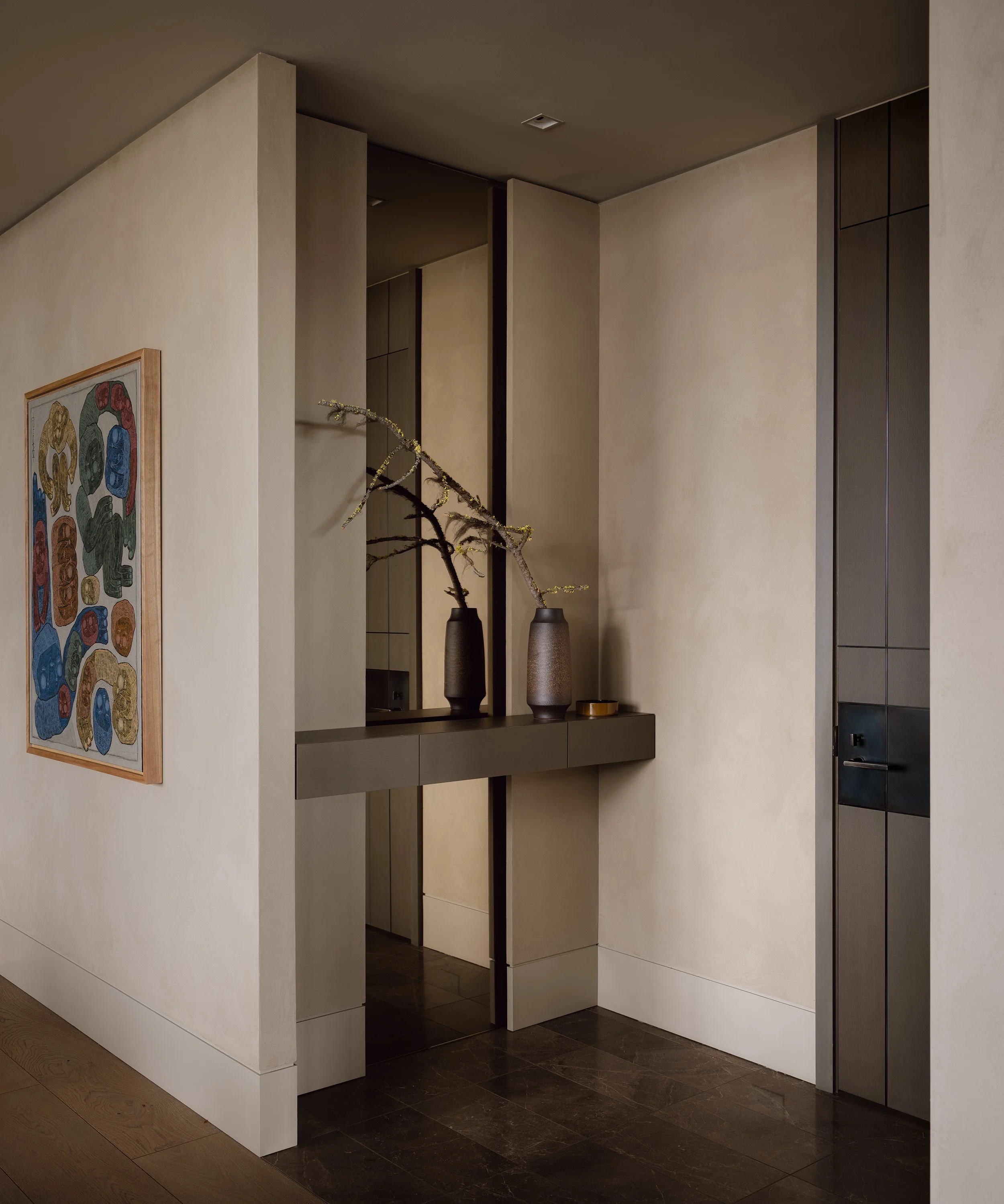 Frameless full length entry mirror, flush wall base, venetian plaster wall finish, floating shelf