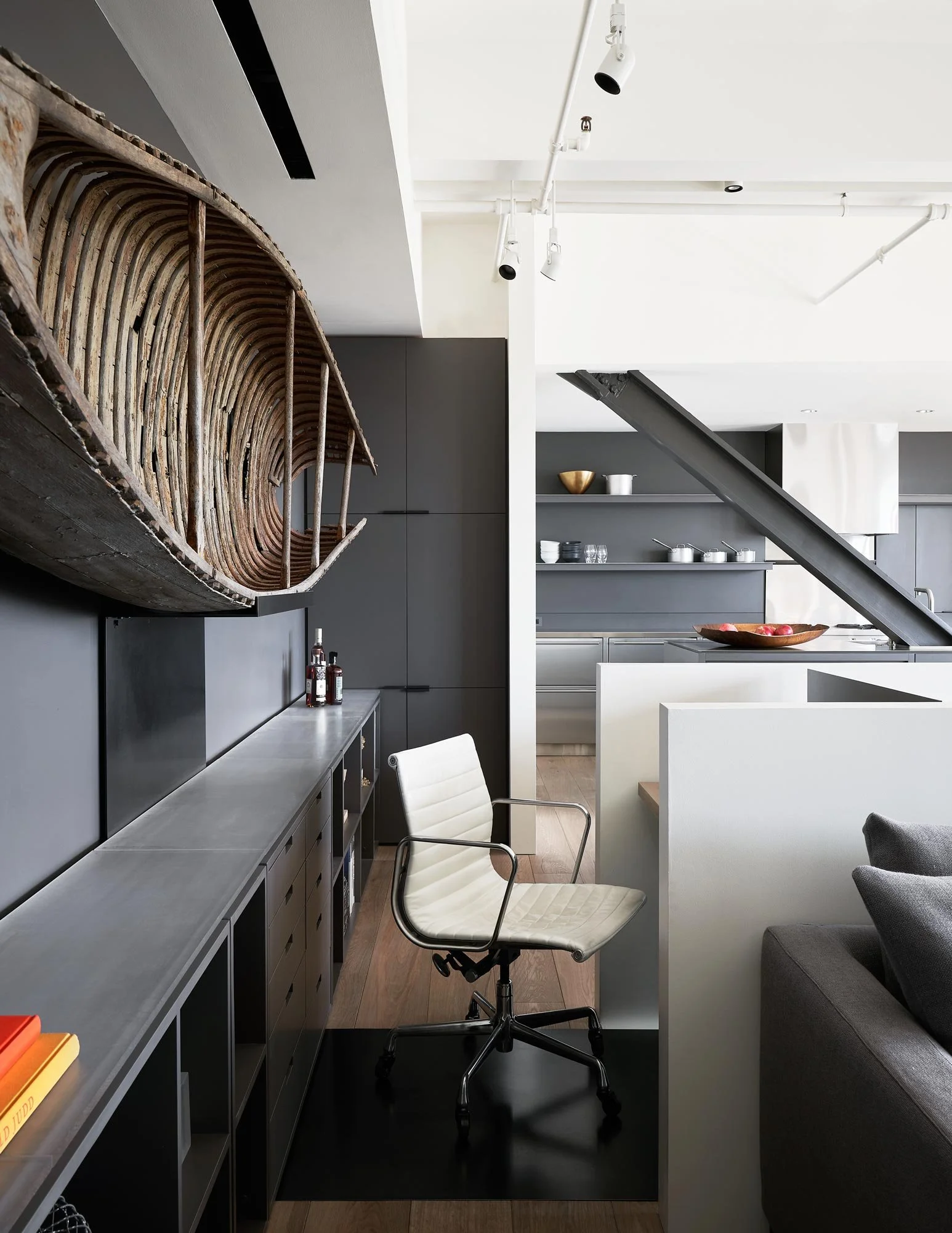 Home office desk, antique canoe art, lucite acrylic countertop, Eames leather office chair, luxury penthouse