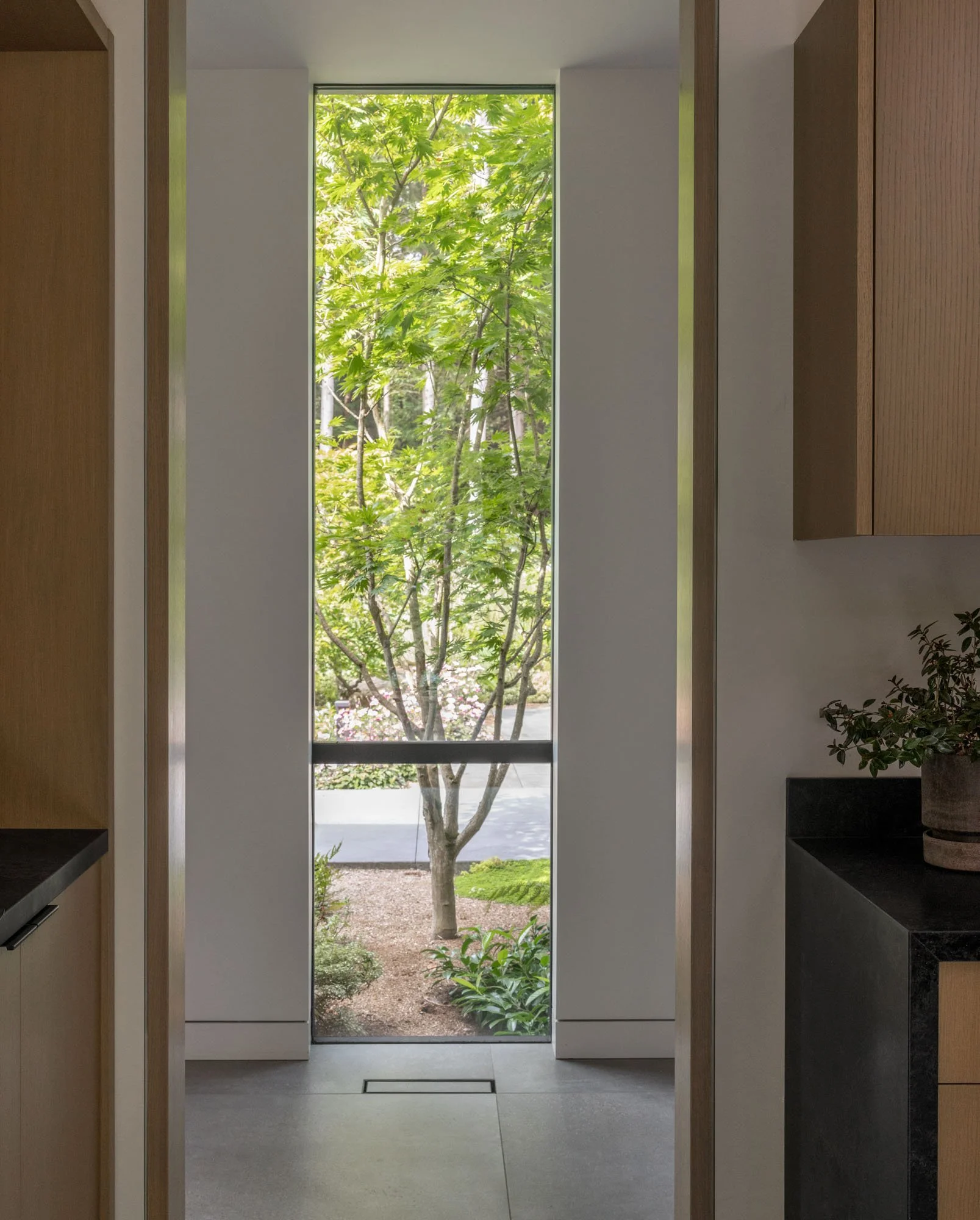 frameless window detailing, framing nature, flush wall base, flush door jambs, hidden floor vents