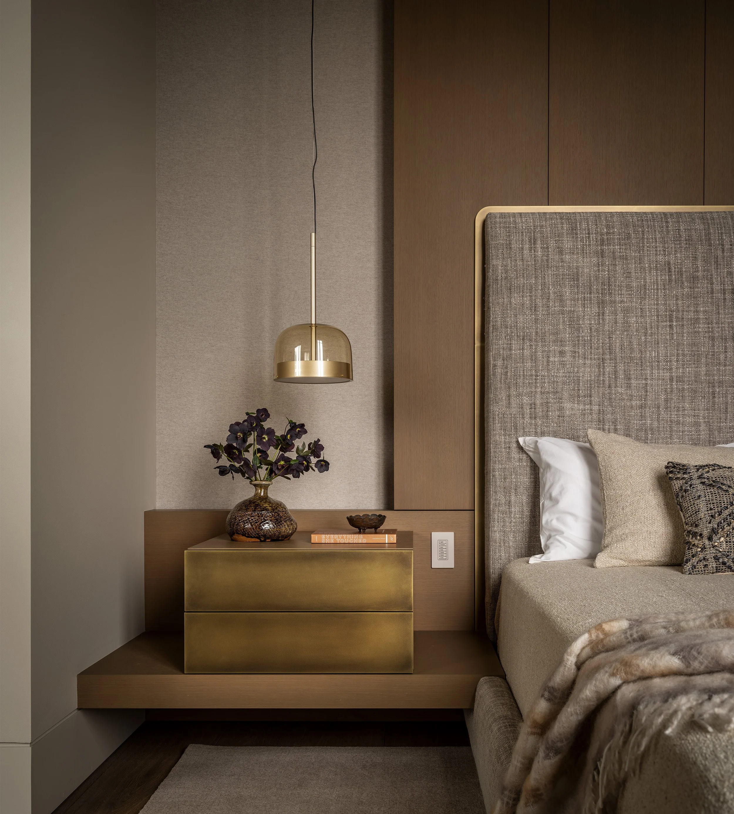 Custom nightstands, bronze casework, flush finger pulls, custm bedframe, upholstered headboard and pendant light