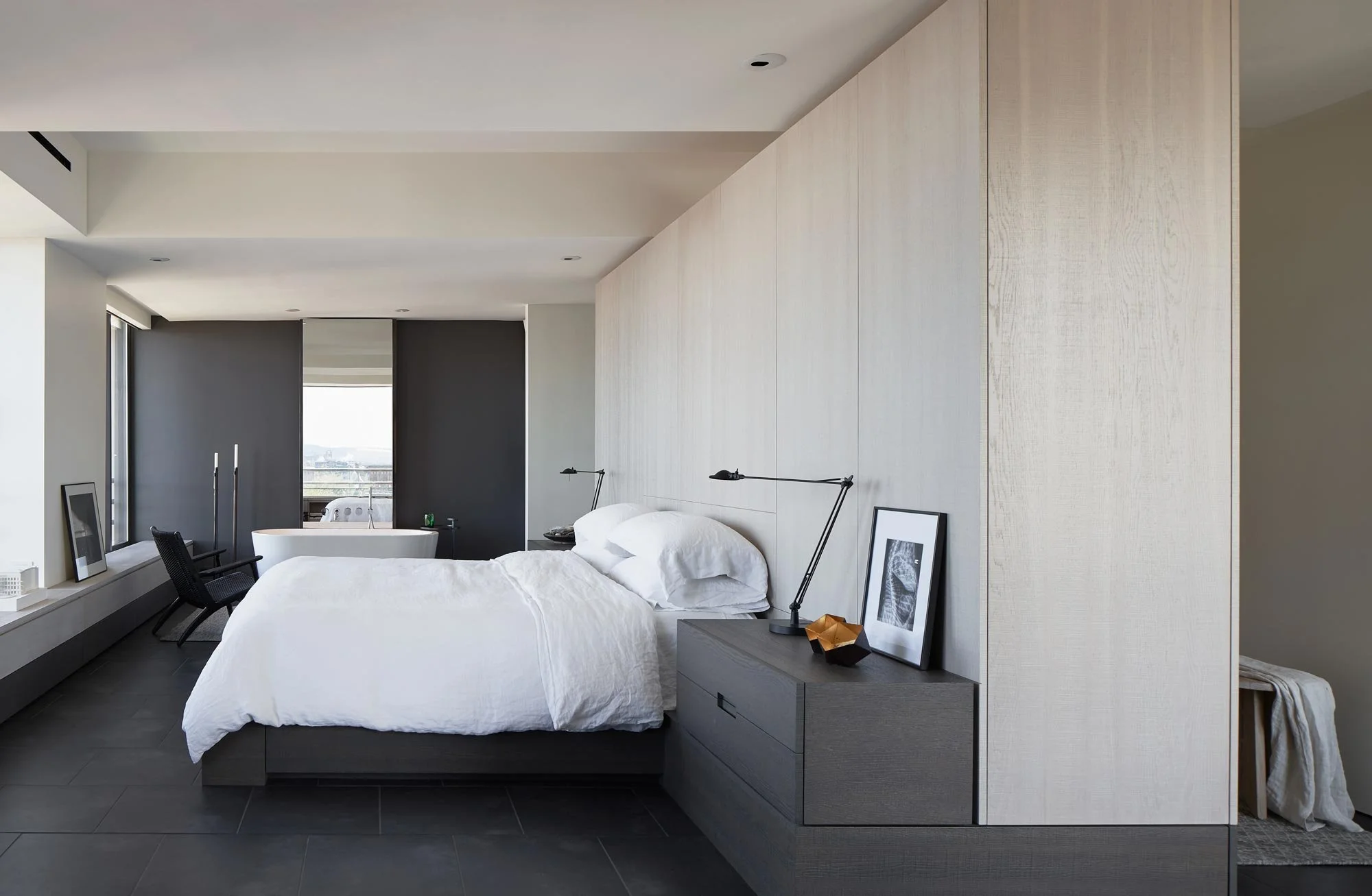 Hotel-like luxury penthouse, freestanding tub as furniture, open plan, minimalist design, black porcelain tile floors