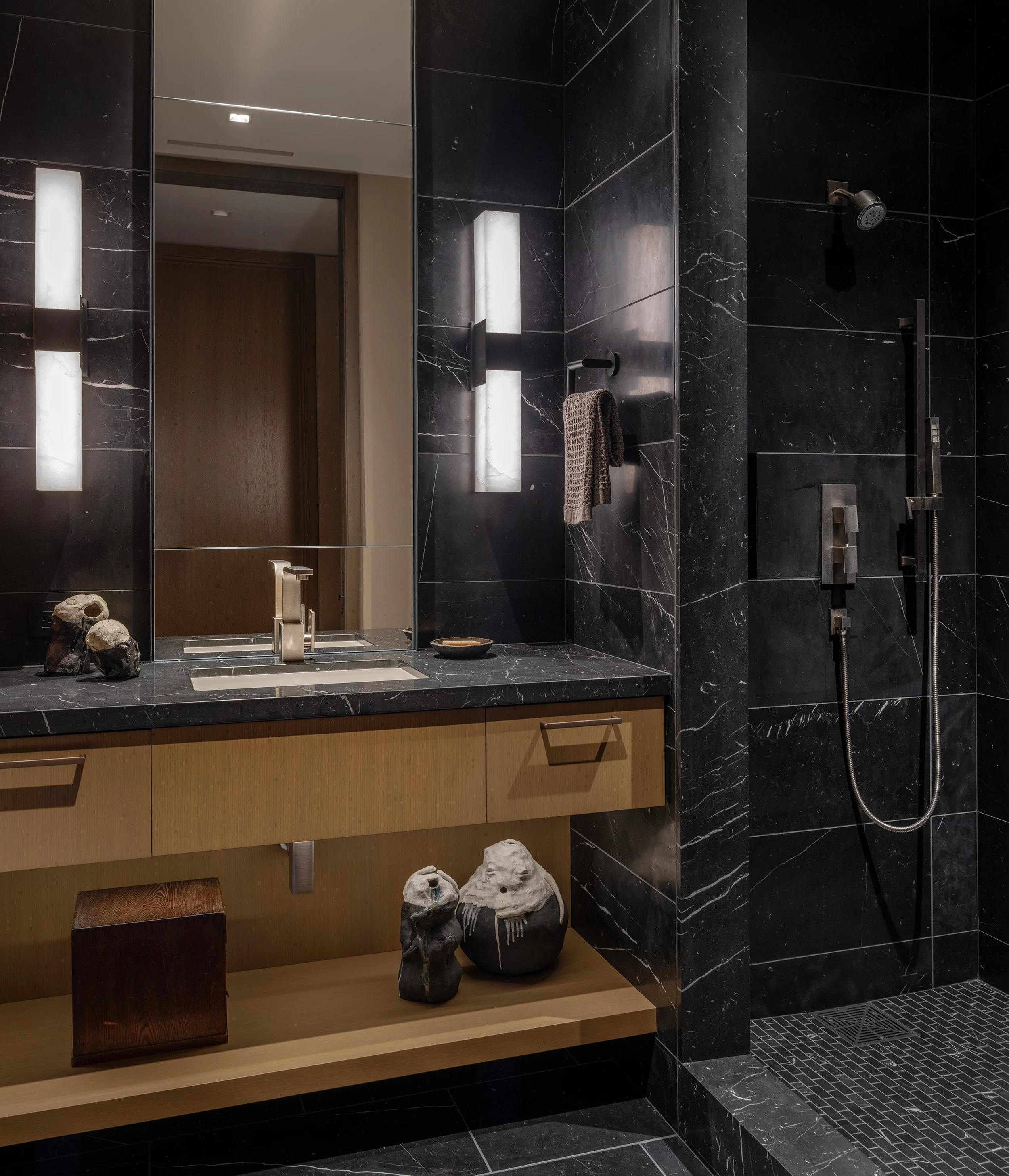 Floating vanity with accessory shelf, stone wall cladding powder room and shower surround