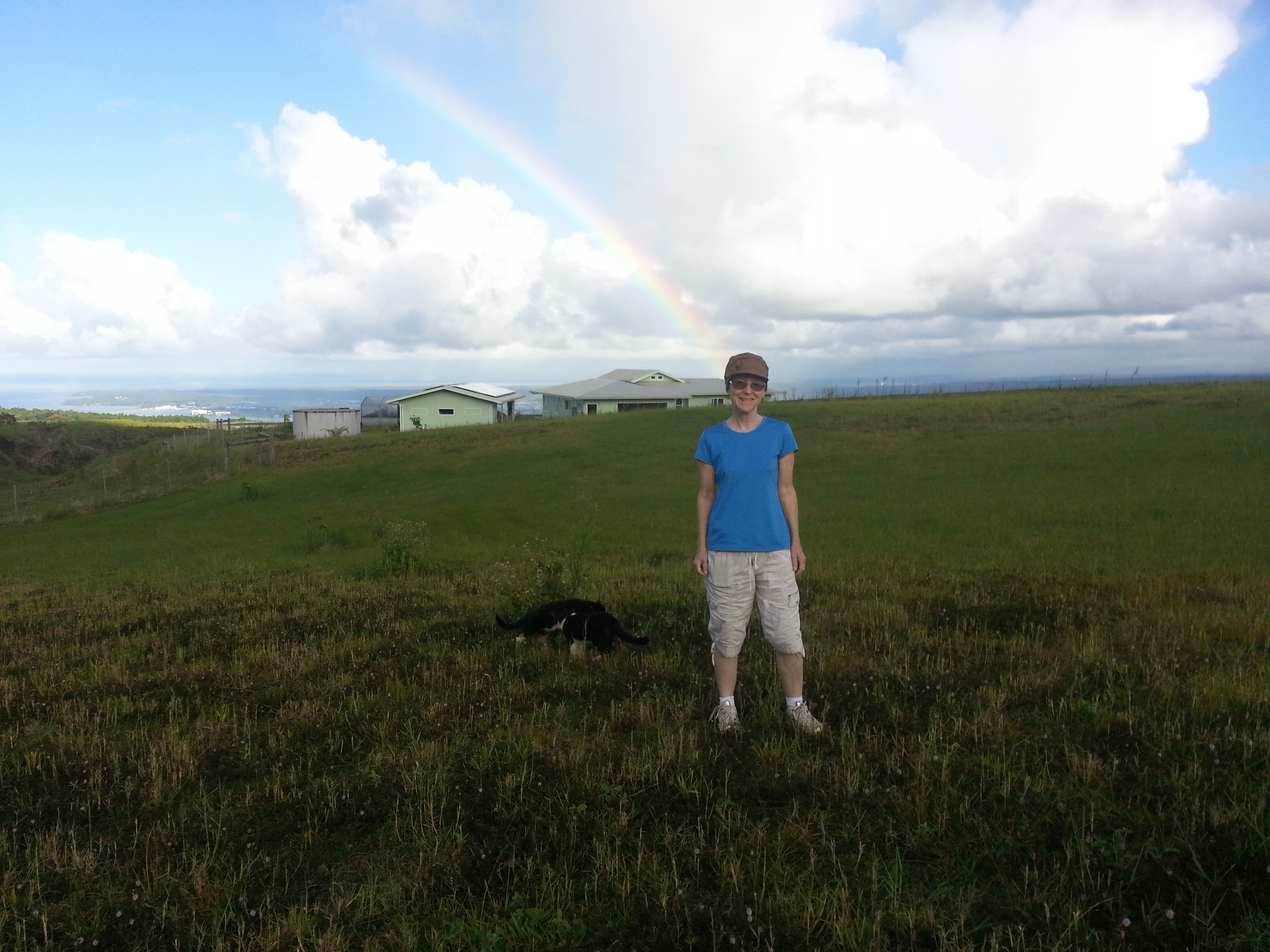 Carol with cats and our house in the background