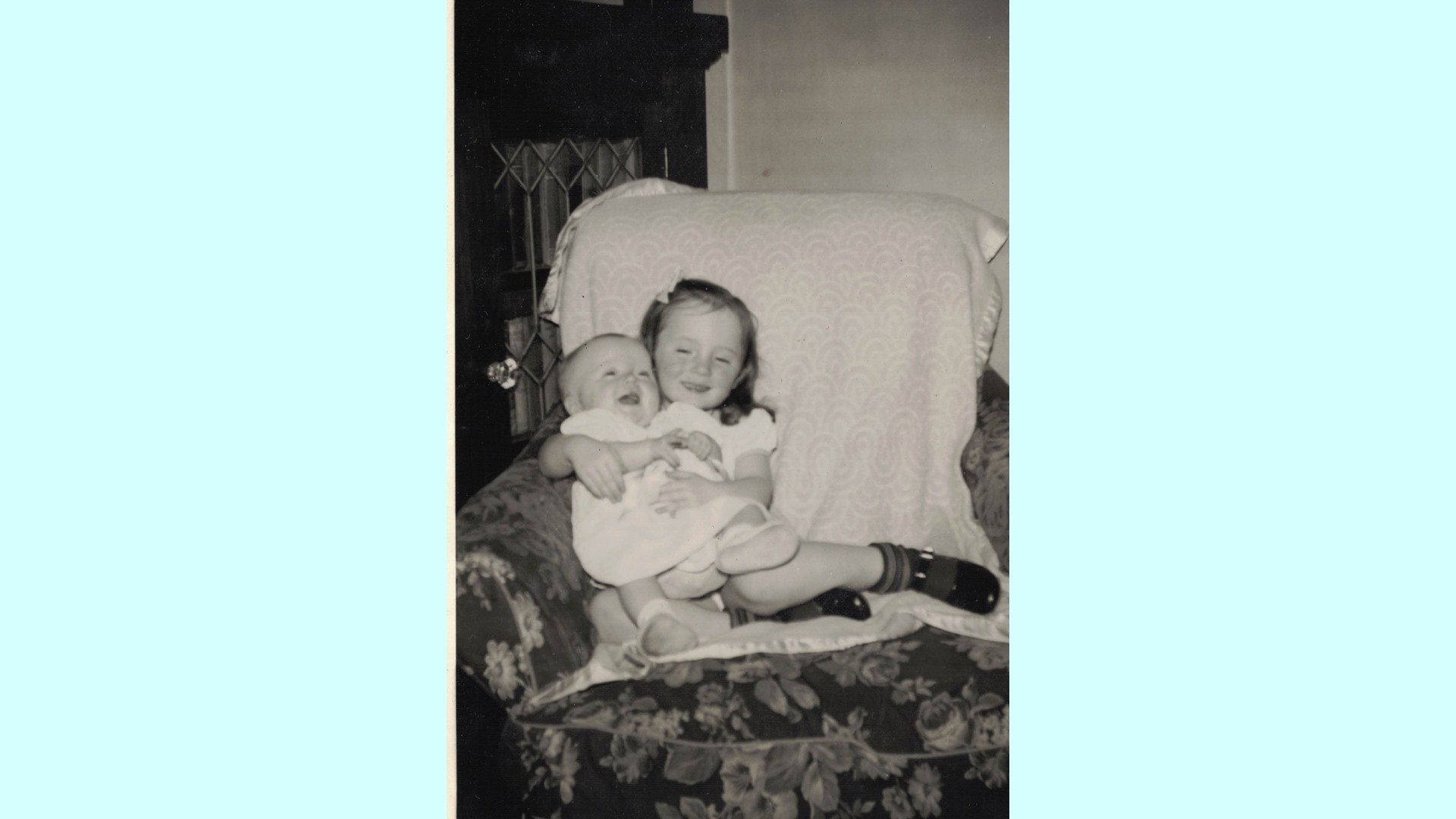 Older sister Jean holding Carol. Feb. 1950.