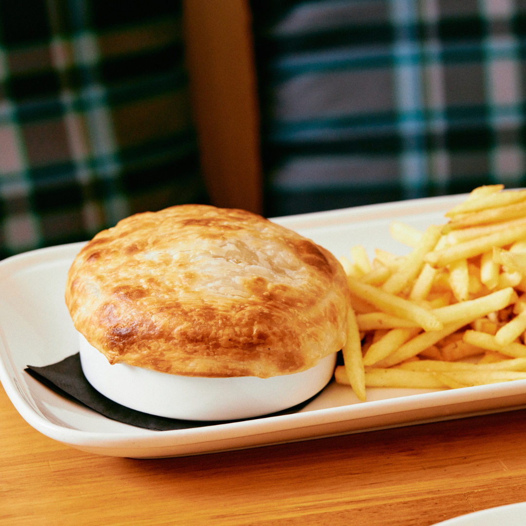 House-made Pie of the Day served at The Mint pub in Melbourne, plated with seasonal sides and rich gravy