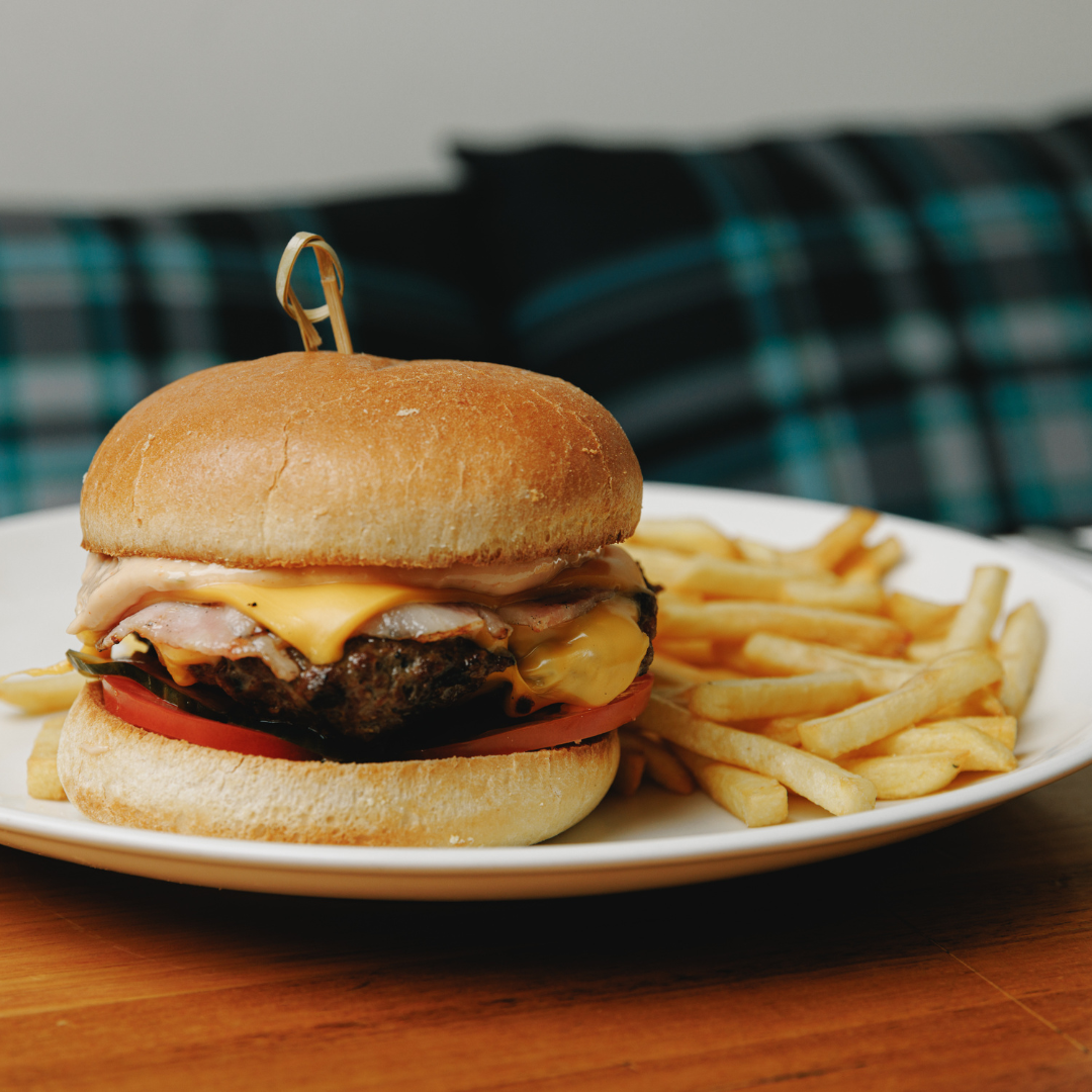 Beef burger with cheese, lettuce, tomato, and house-made sauce, served with French fries at The Mint pub in Melbourne