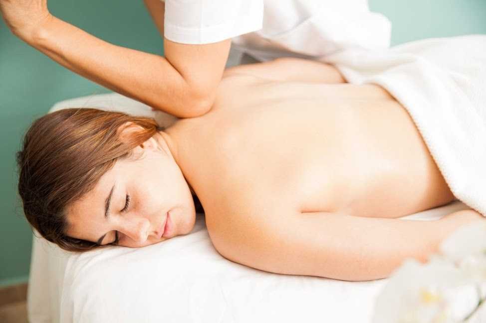 A massage therapist applying firm pressure and targeted techniques to administer a deep tissue massage, focusing on muscle tension release and therapeutic benefits.