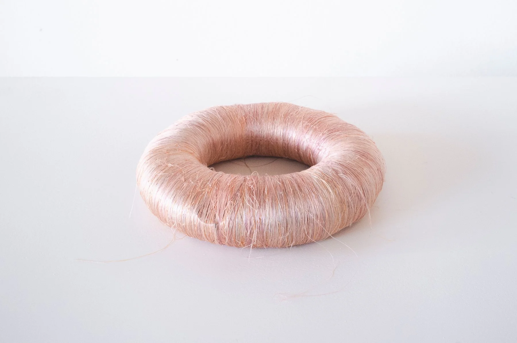 'Extracts of Care (2020)', 2020.
Silk, porcelain. 3 × 12 × 12 cm.
Photography: Tim Spreadbury.