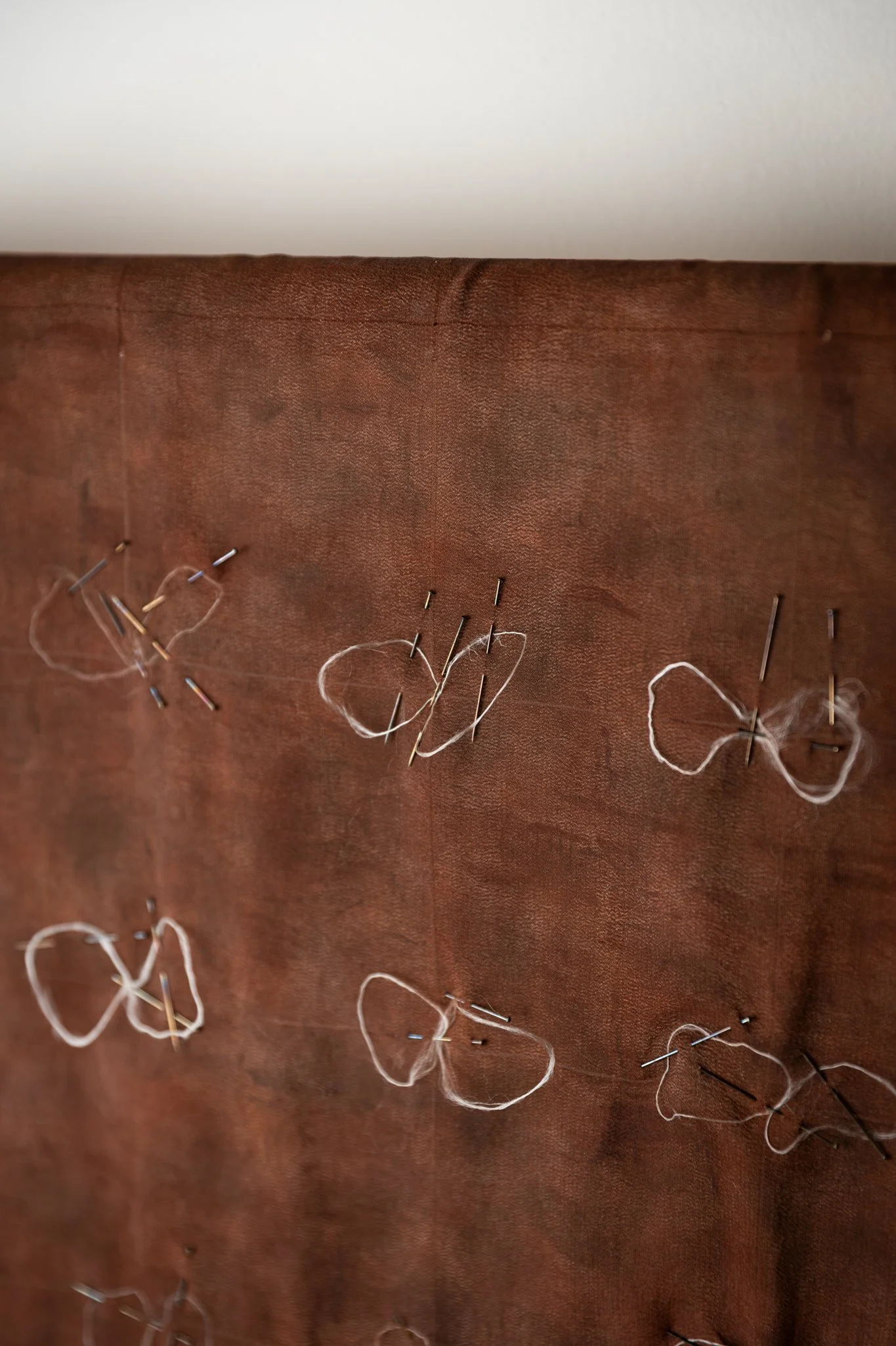 'Secretions' (detail), 2025. Crepe de chine, silk filament, pigment, oxidised steel pins. 73 x 73 cm. Photography: Joseph Hall.