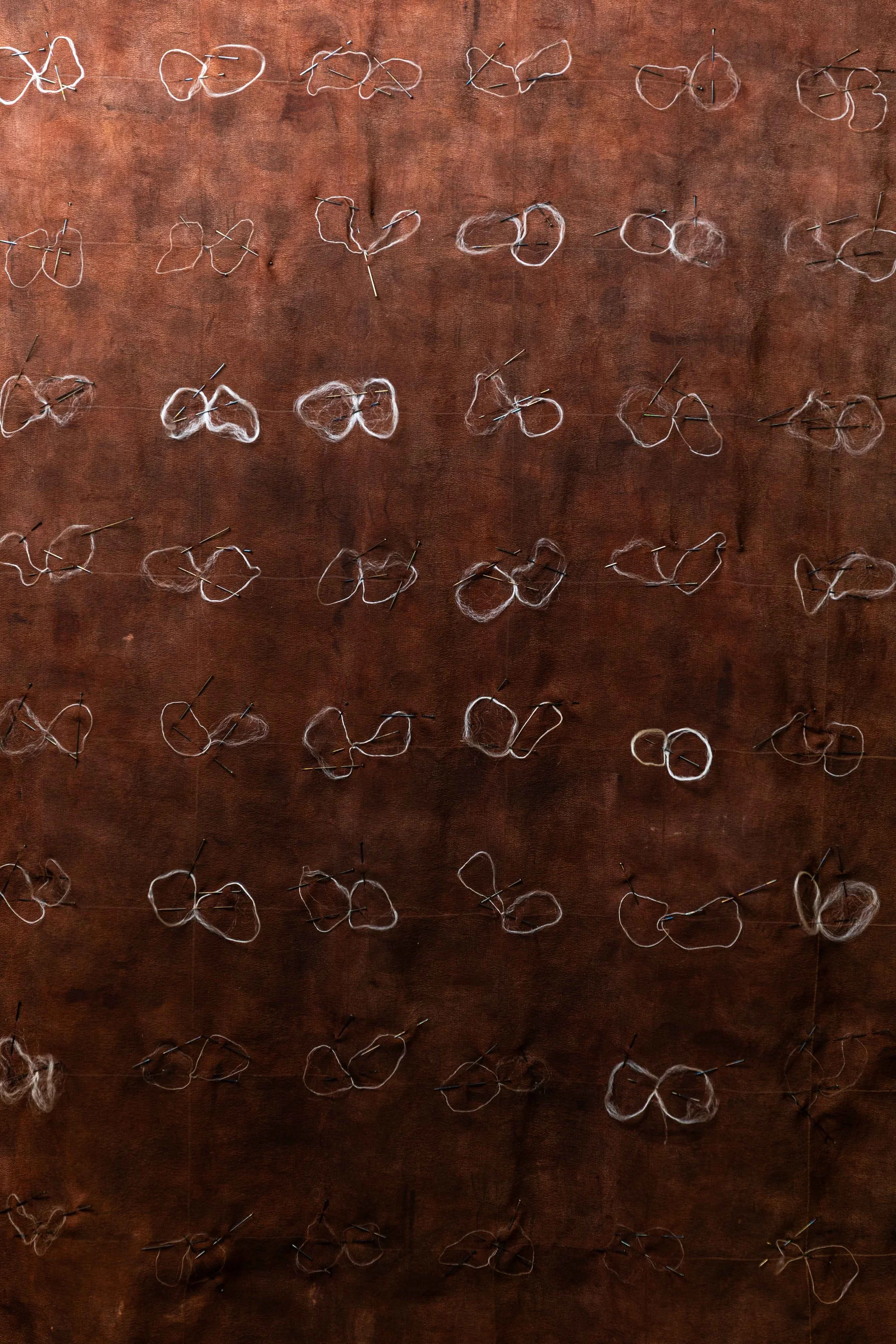 'Secretions', (detail), 2025. Crepe de chine, silk filament, pigment, oxidised steel pins. 73 x 73 cm. Presented as part of 'RCA Research Biennale 2025', Royal College of Art, London. Photography: Joseph Hall.