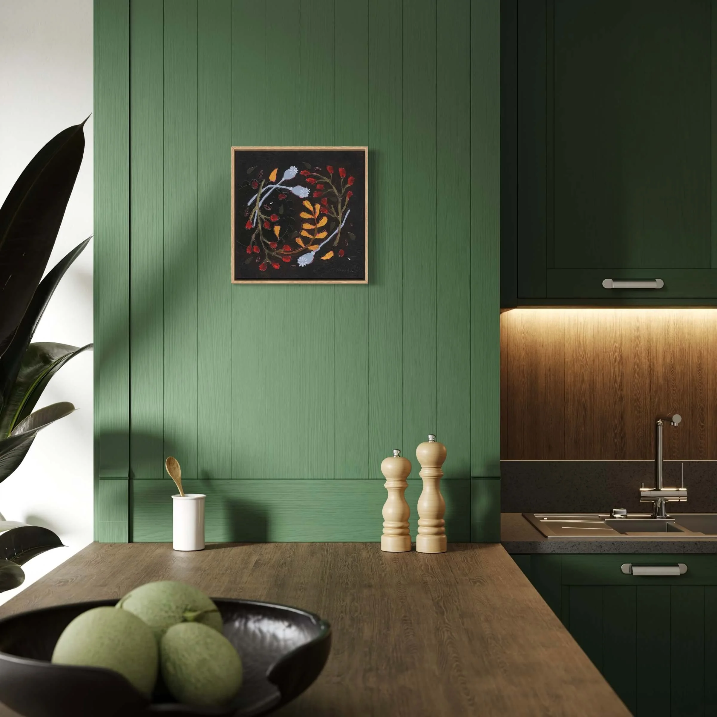 Framed artwork Wilda by Ali Mackie Art mounted on a sage green panelling wall in a modern kitchen setting above wooden countertops.