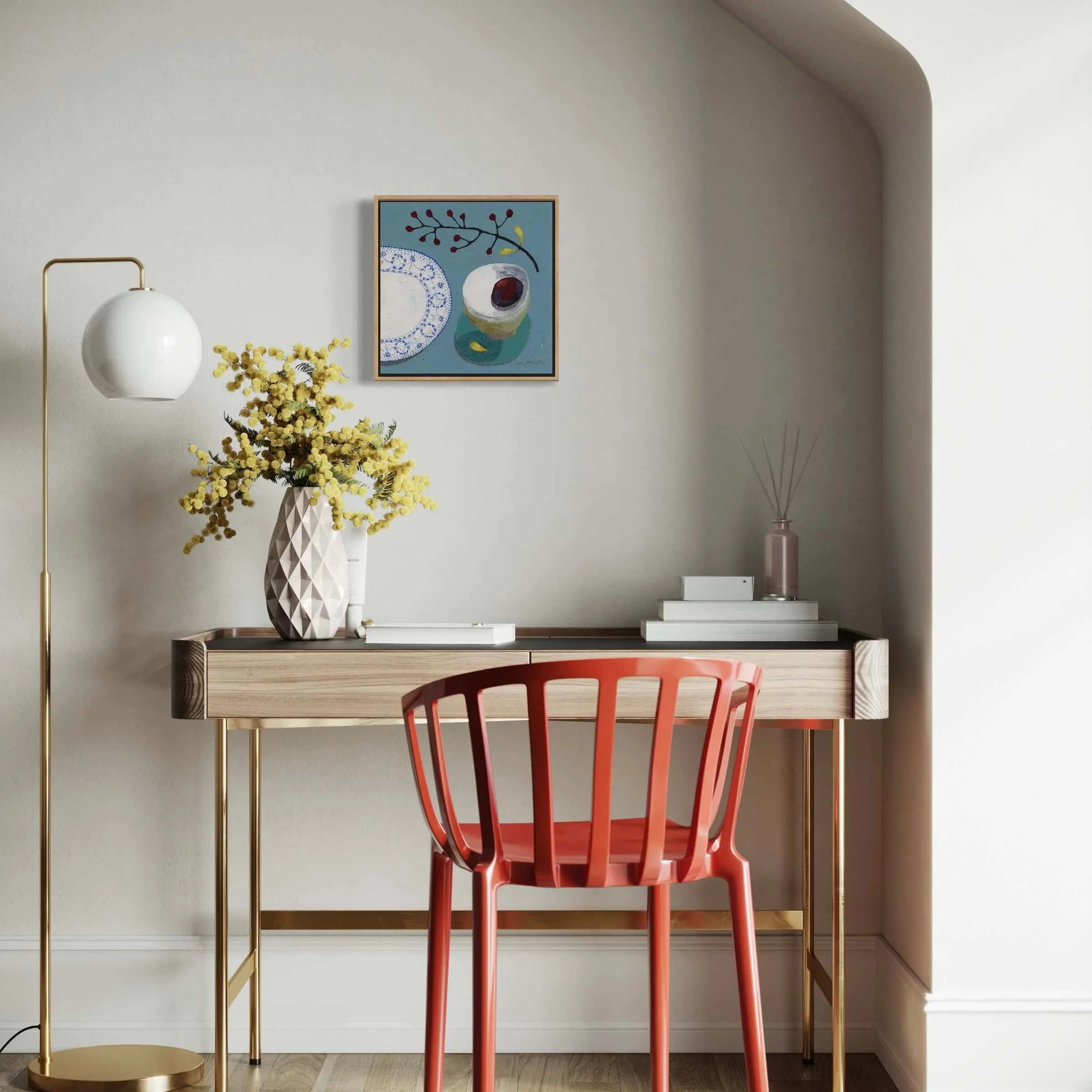 Modern interior room mockup with framed wall art Lets Sit Together by Ali Mackie Art hung above a desk and red chair.
