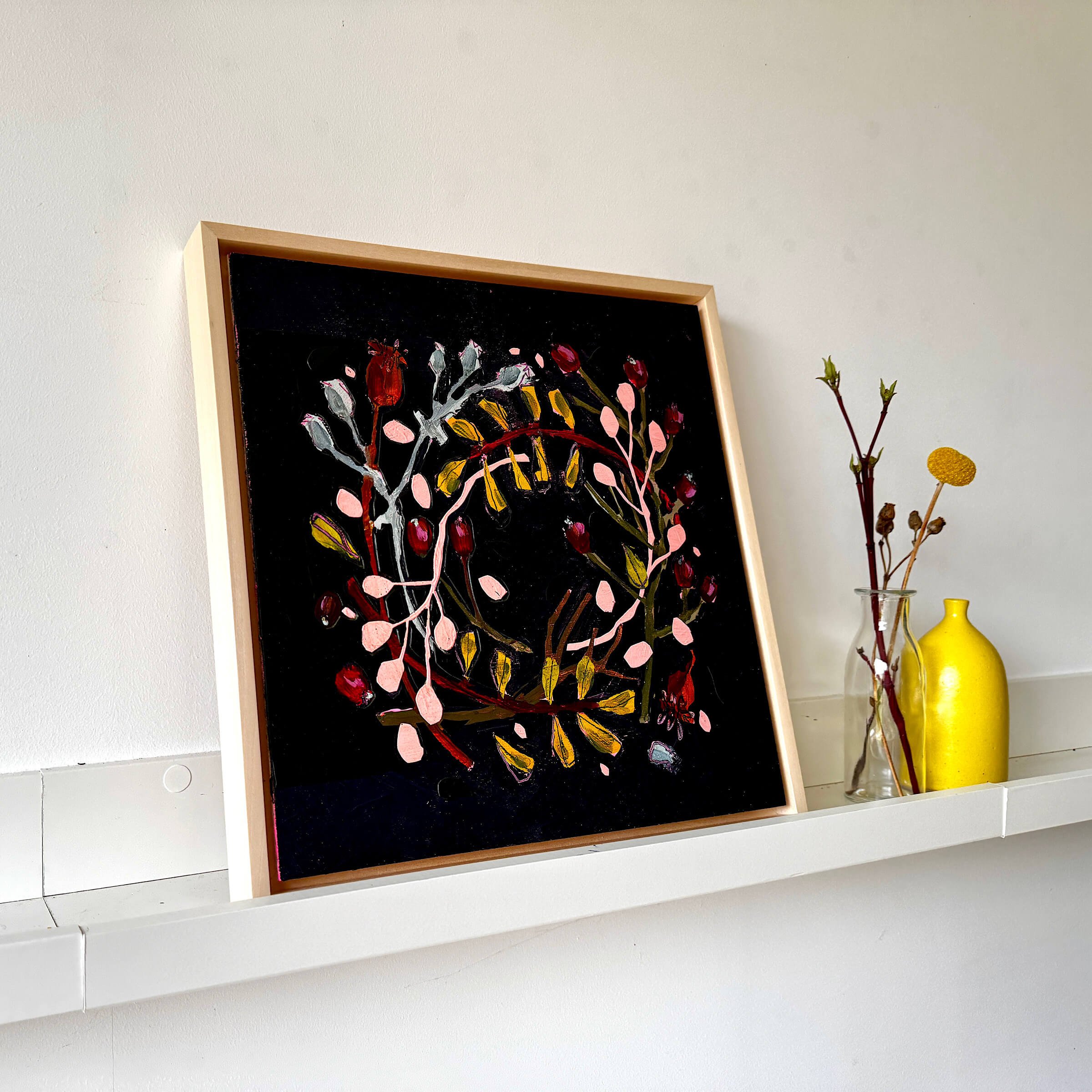 Front view of Wallis framed moody botanical painting featuring pink branches and red berries against a black background.