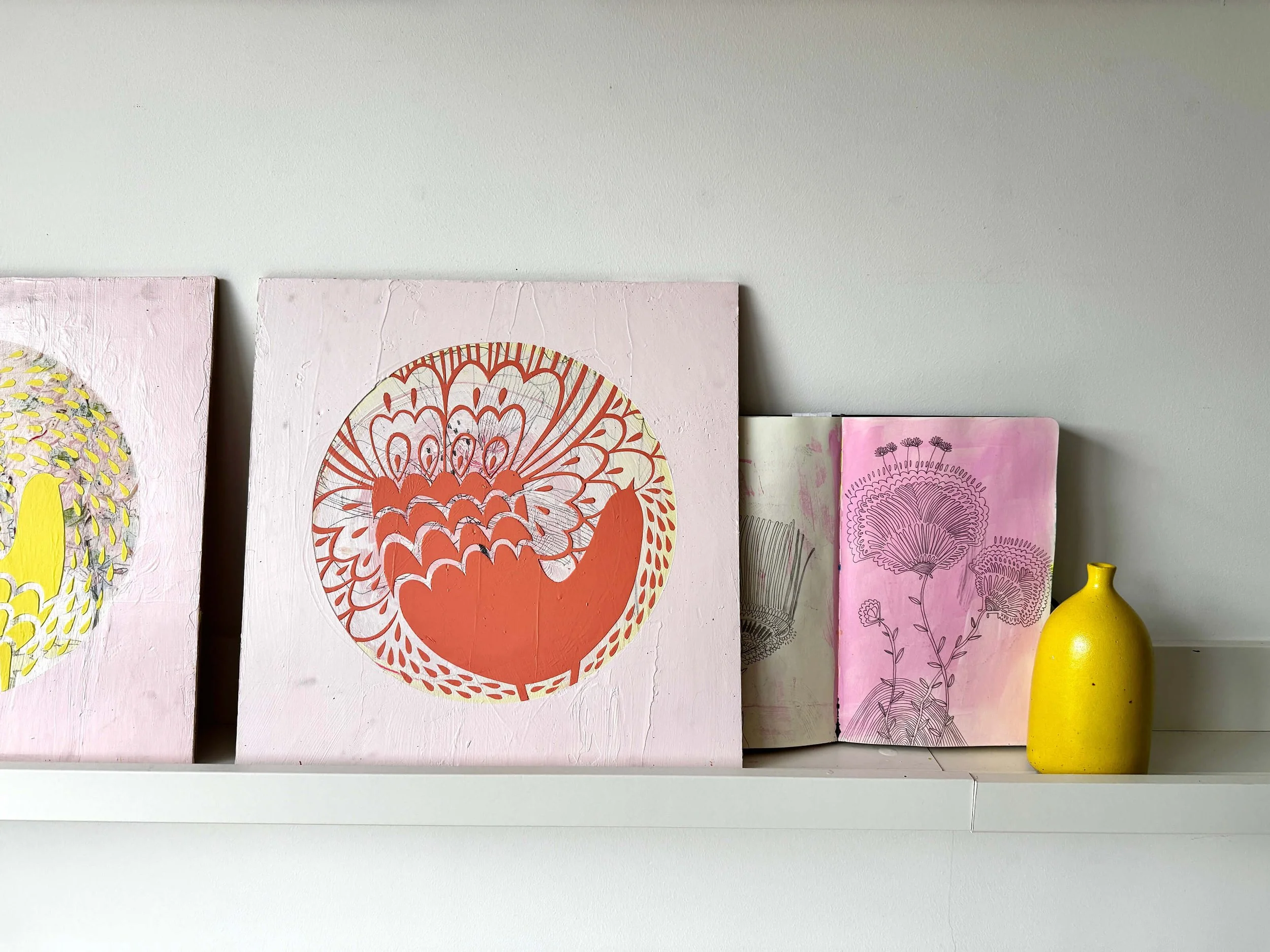 Behind-the-scenes look at Ali Mackie’s creative process and sketchbook inspiration for her colorful contemporary folk-art pieces featured in The Tender Future exhibition at Emerald Frames & Gallery.