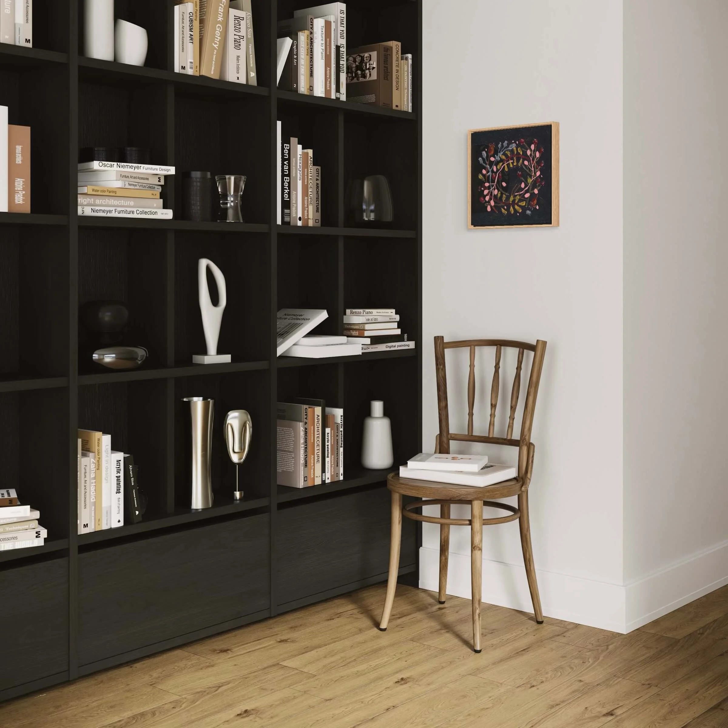 Ali Mackie framed botanical wreath artwork displayed in a cozy reading corner with dark wood bookshelves.