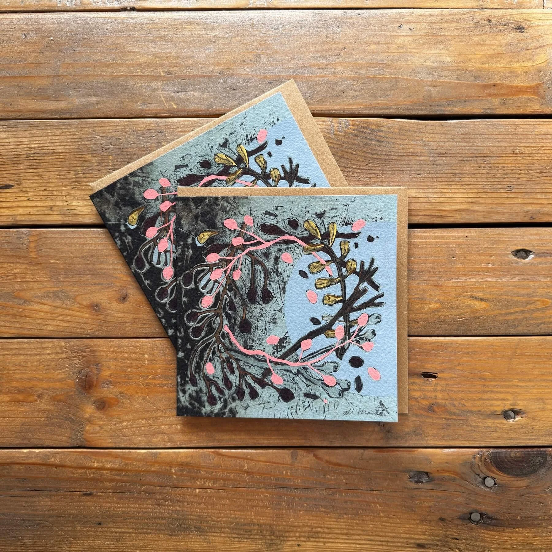 Pair of abstract dark botanical wreath Christmas greeting cards with pink berries and gold accents.