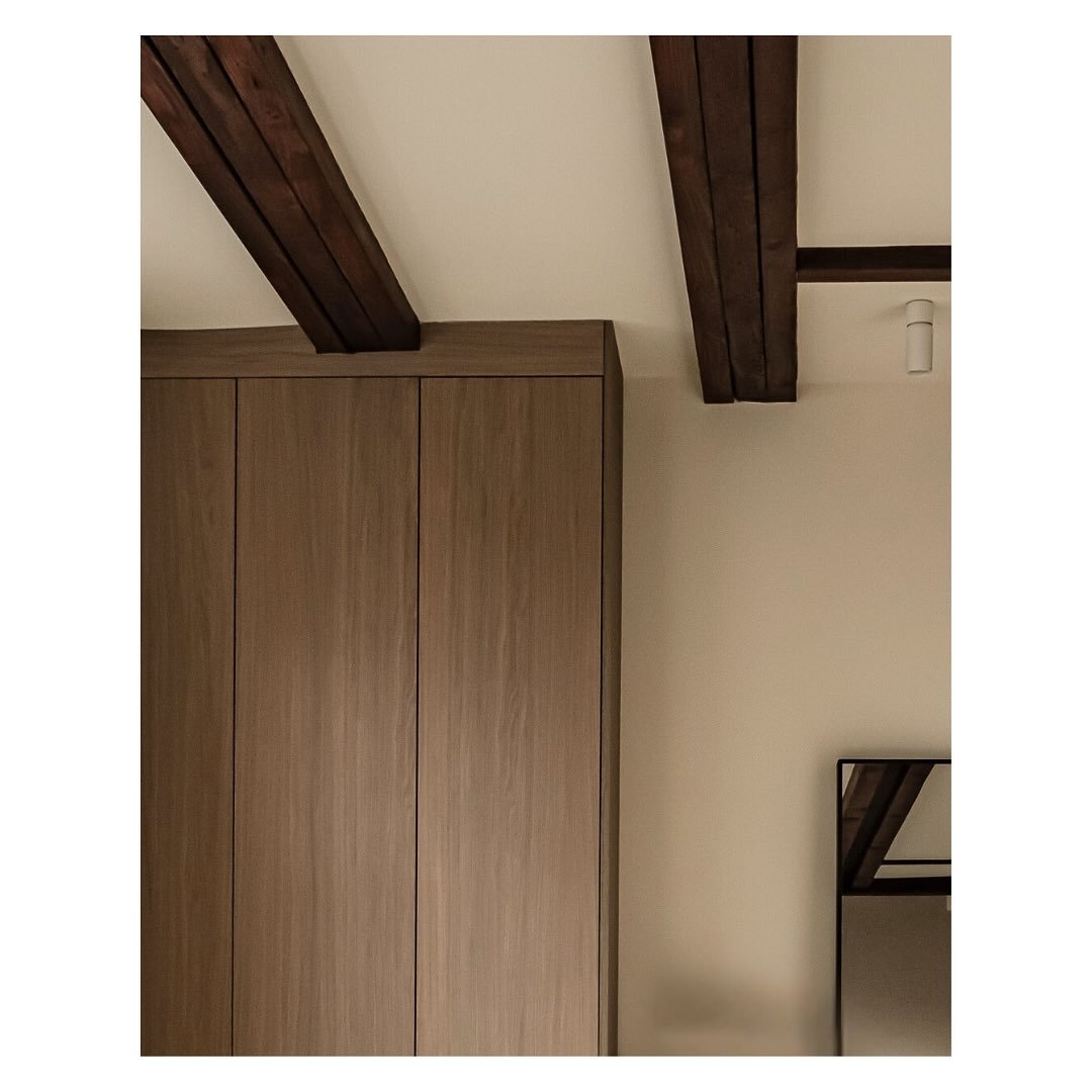 Lounge cabinetry and exposed ceiling beams..

We removed the existing low ceilings, raised the new ceiling level and exposed the original wooden beams. We oiled the wooden beams a dark chocolate stain and installed directional lighting to accentuate 