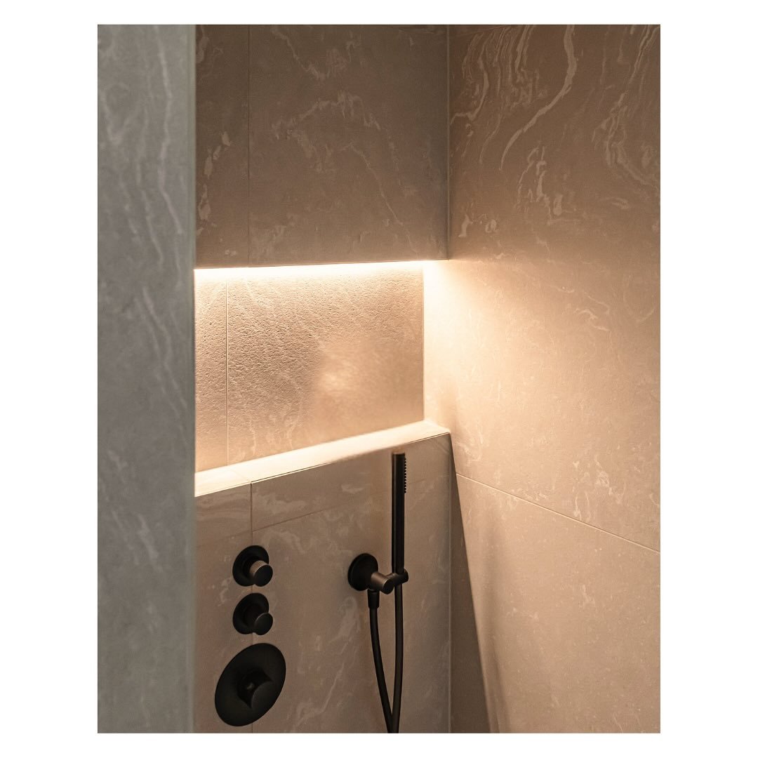 Bathroom details..

We created a functional yet aesthetically pleasing niche in the shower, highlighted by soft concealed lighting. 

The bathroom is made up of soft, emotive tiles with wooden furniture and anthracite tap fixtures. It is a calm space