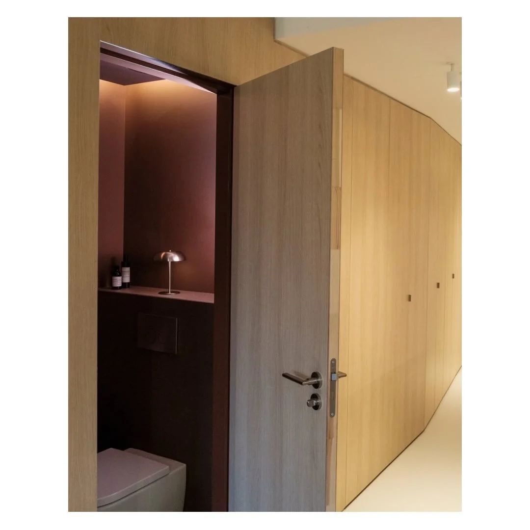 A bespoke designed storage wall; concealing a laundry, coat storage and even a wc. Wooden cabinetry is repeated into the kitchen space creating seamless continuity throughout the apartment.

Design by @studio___p3 
Photography by @justinreidross 

#a
