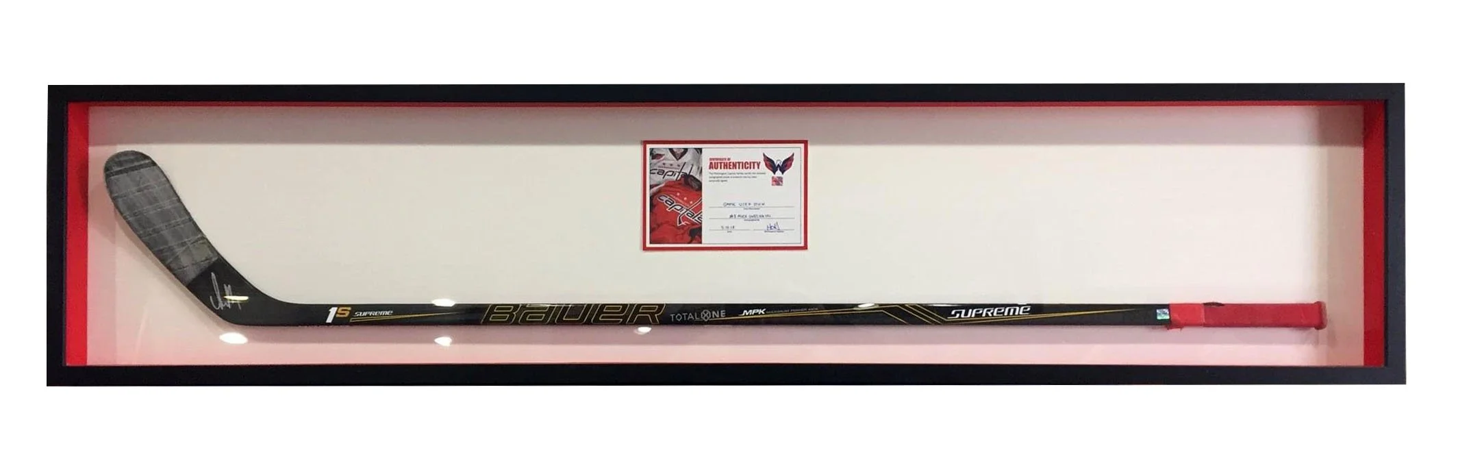 Hockey stick in a display case with a certificate of authenticity