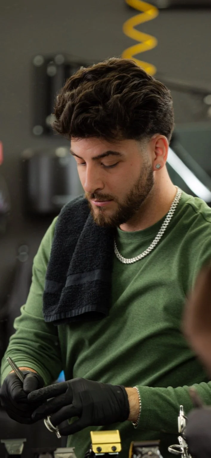 Ru, Beauty Culture barber, working with scissors and a comb