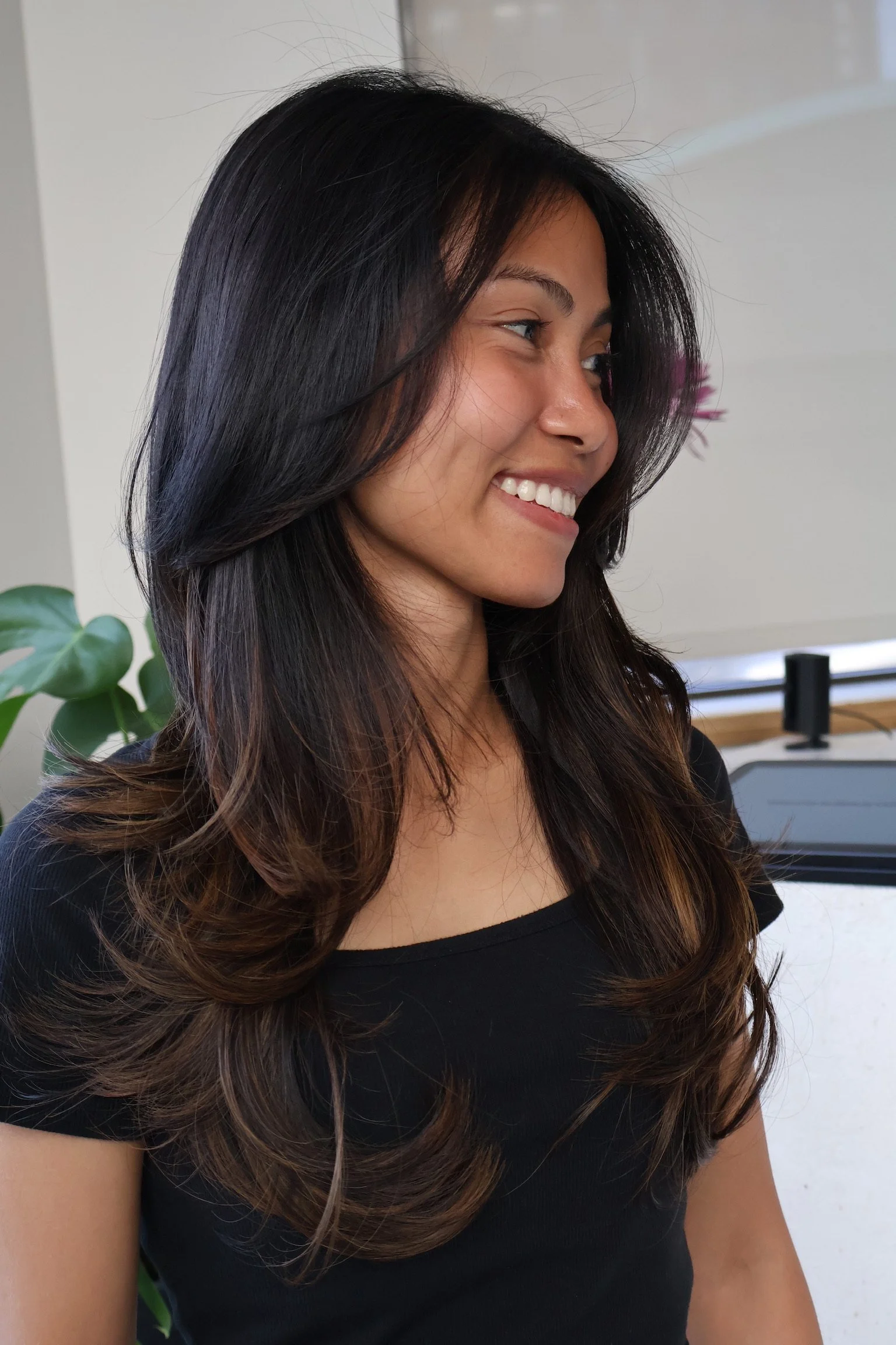 Dark layered hair with warm brown color through the ends