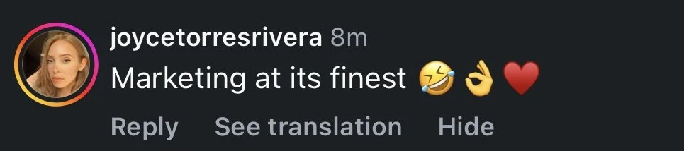 Instagram comment saying, 'Marketing at its finest' with laughing, OK hand, and red heart emojis.