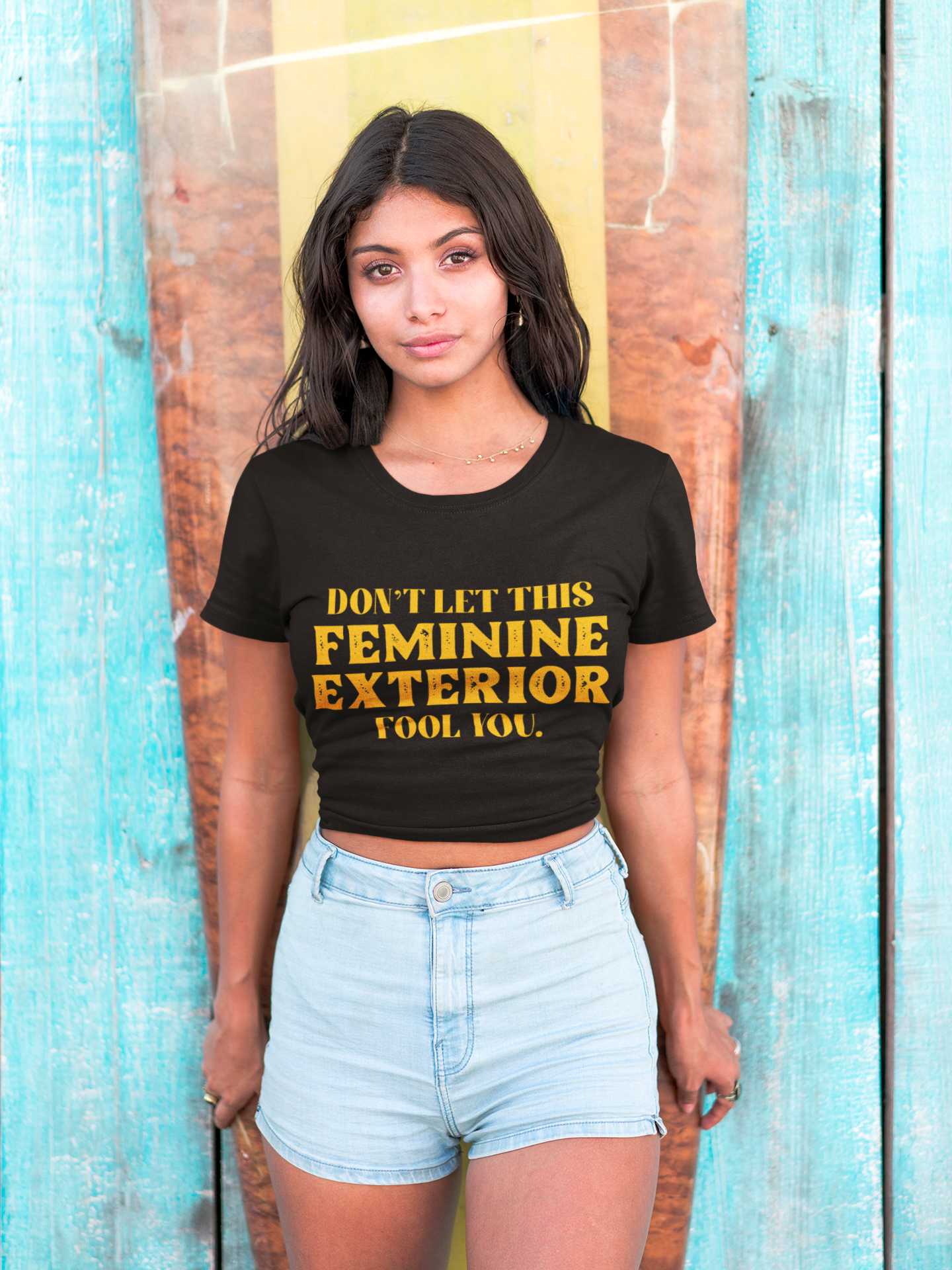 hispanic-girl-wearing-a-tshirt-mockup-standing-against-a-surfboard-a18806.png
